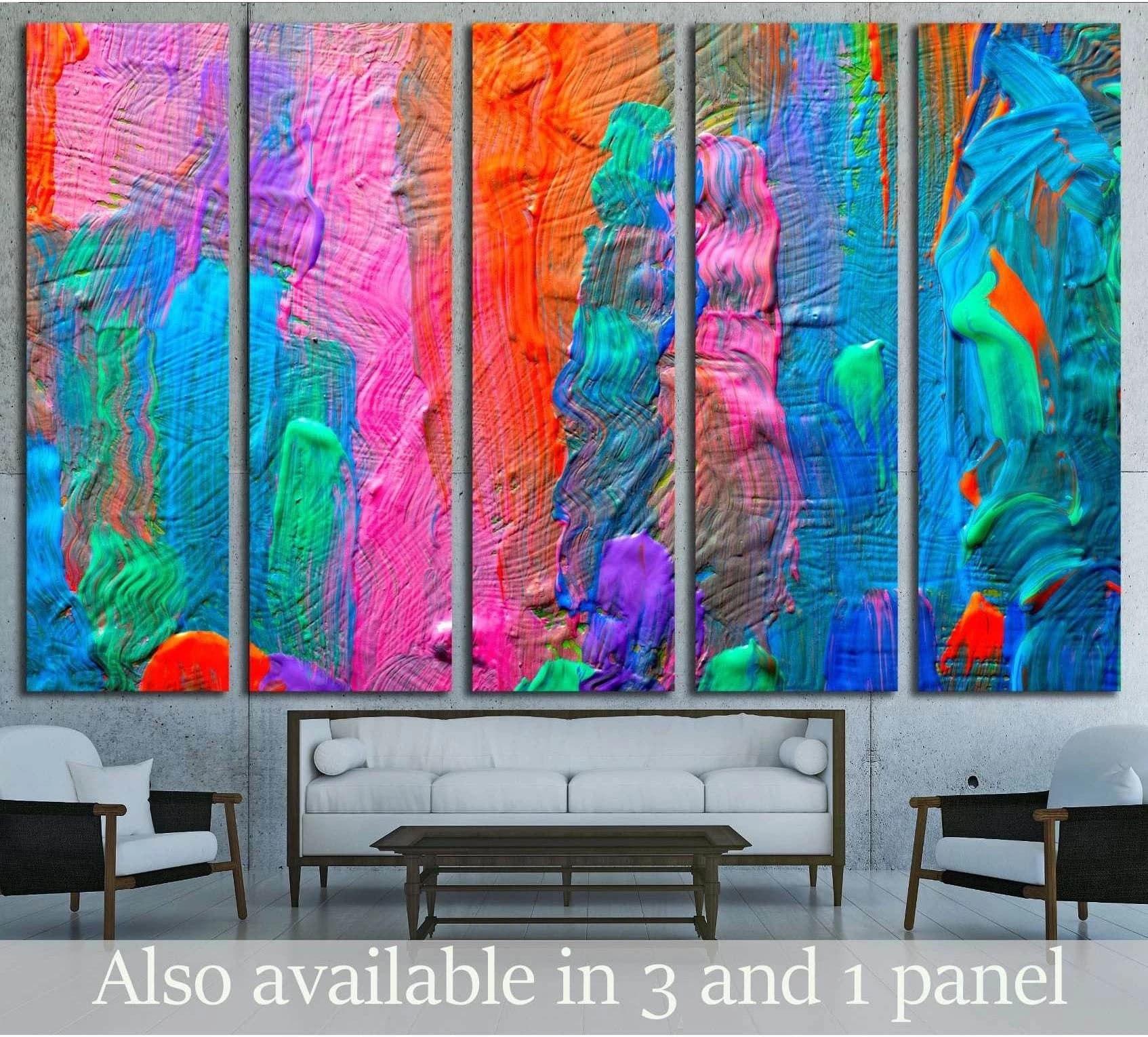 Colorful abstract canvas print with pink orange blue and teal textured panels above a sofa