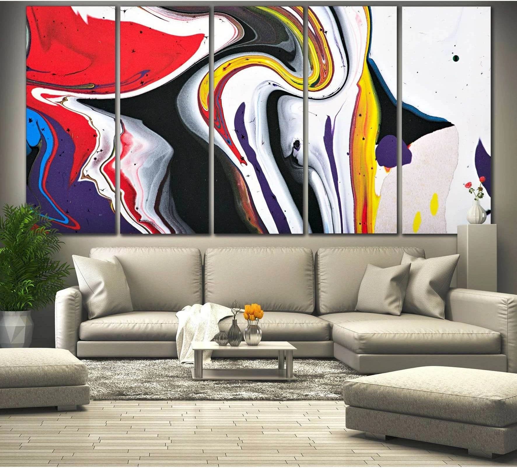 Abstract marbled canvas print with red, yellow, black, white, and purple swirls above a sofa in a modern living room