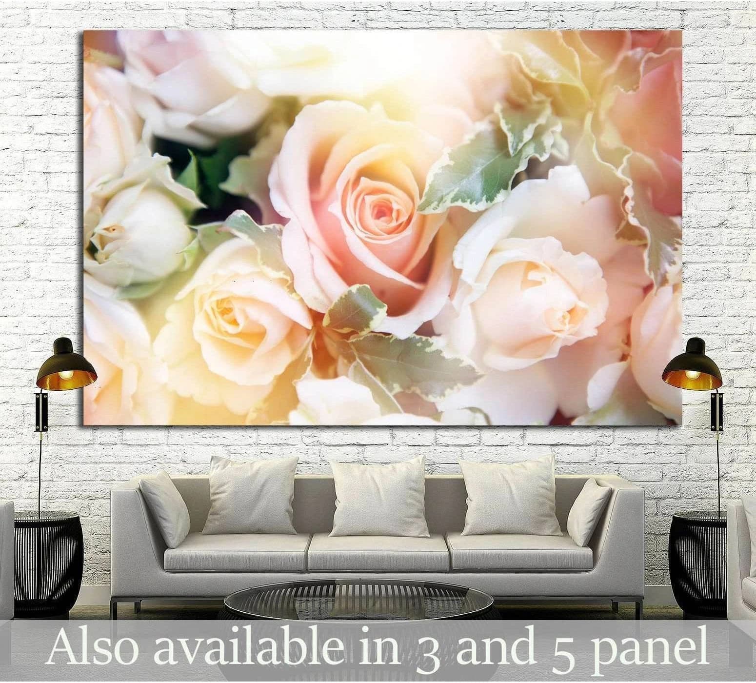 Blush rose canvas print with soft peach, cream, and ivory flowers above a sofa in a neutral living room