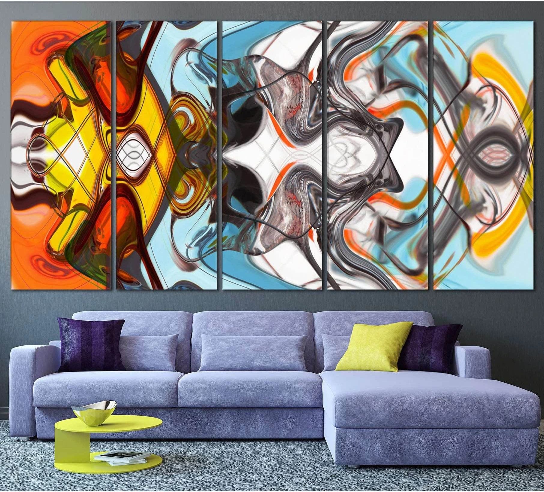 Symmetrical abstract canvas print with orange, yellow, aqua, black, and gray swirls above a modern sofa