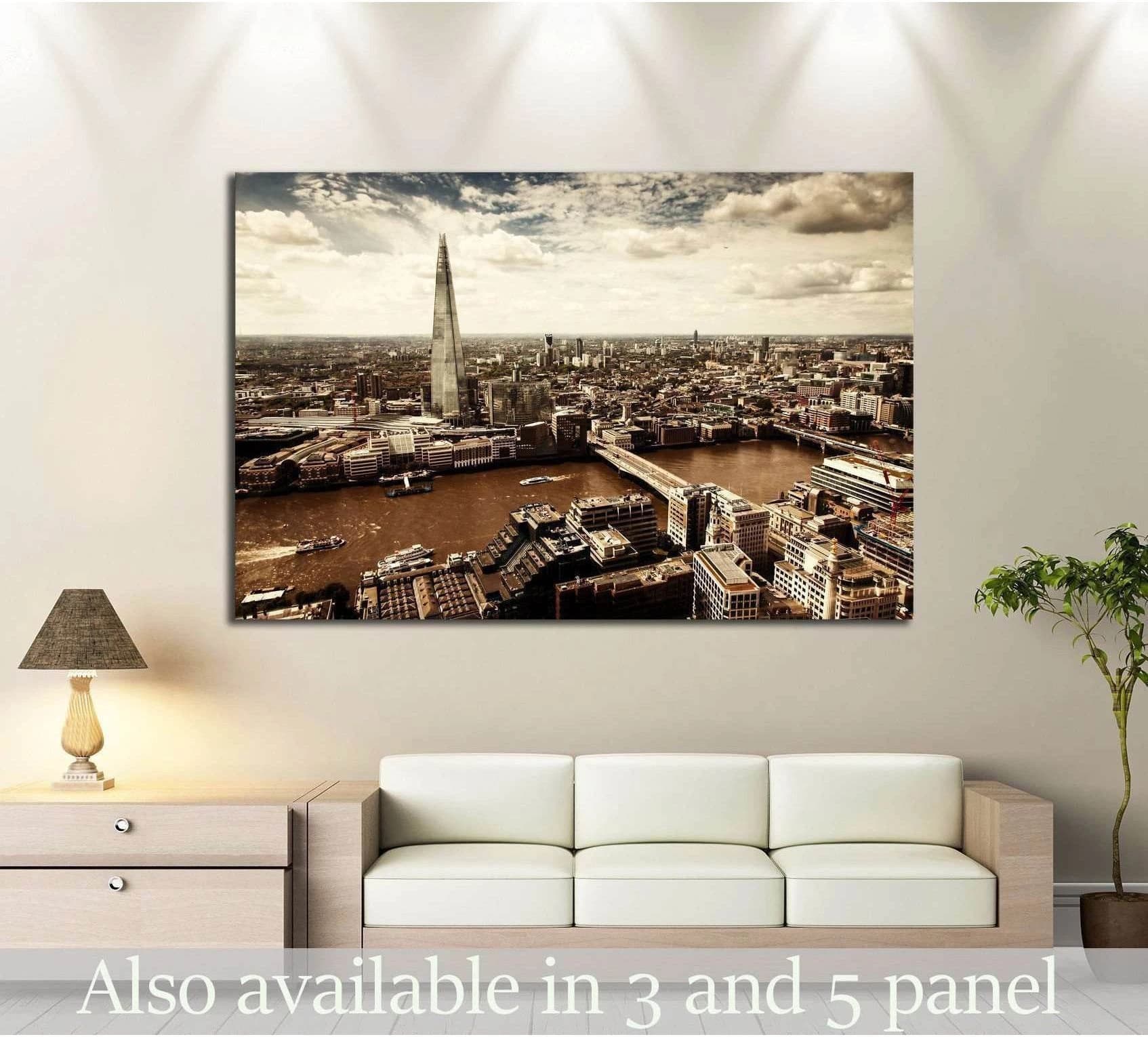 London aerial view canvas print with The Shard and River Thames above a sofa in a modern living room