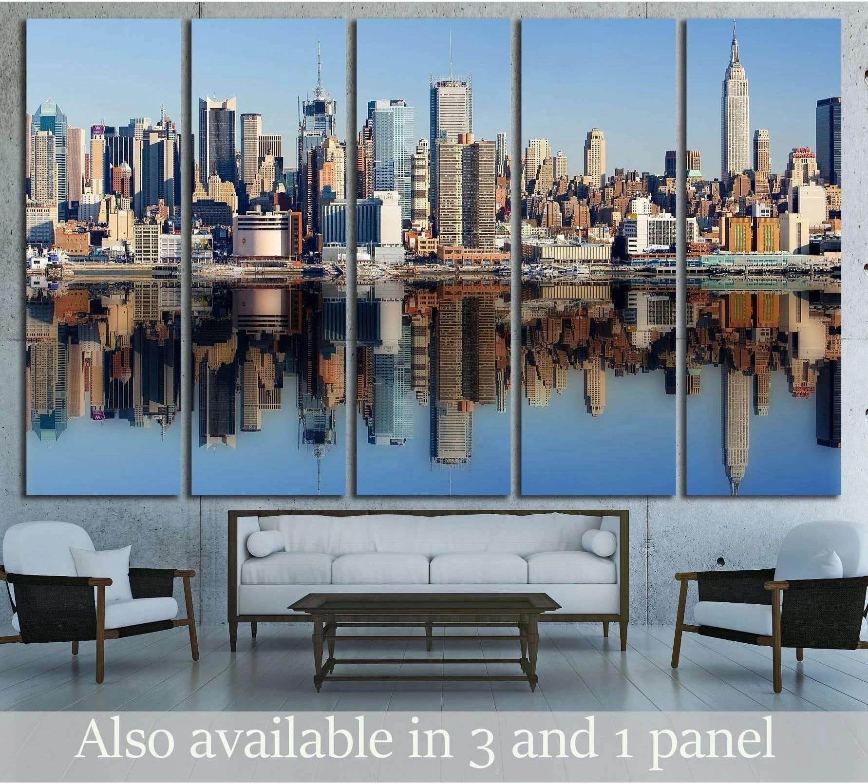 New York City skyline canvas print with Manhattan waterfront reflection hung above a sofa in a modern living room