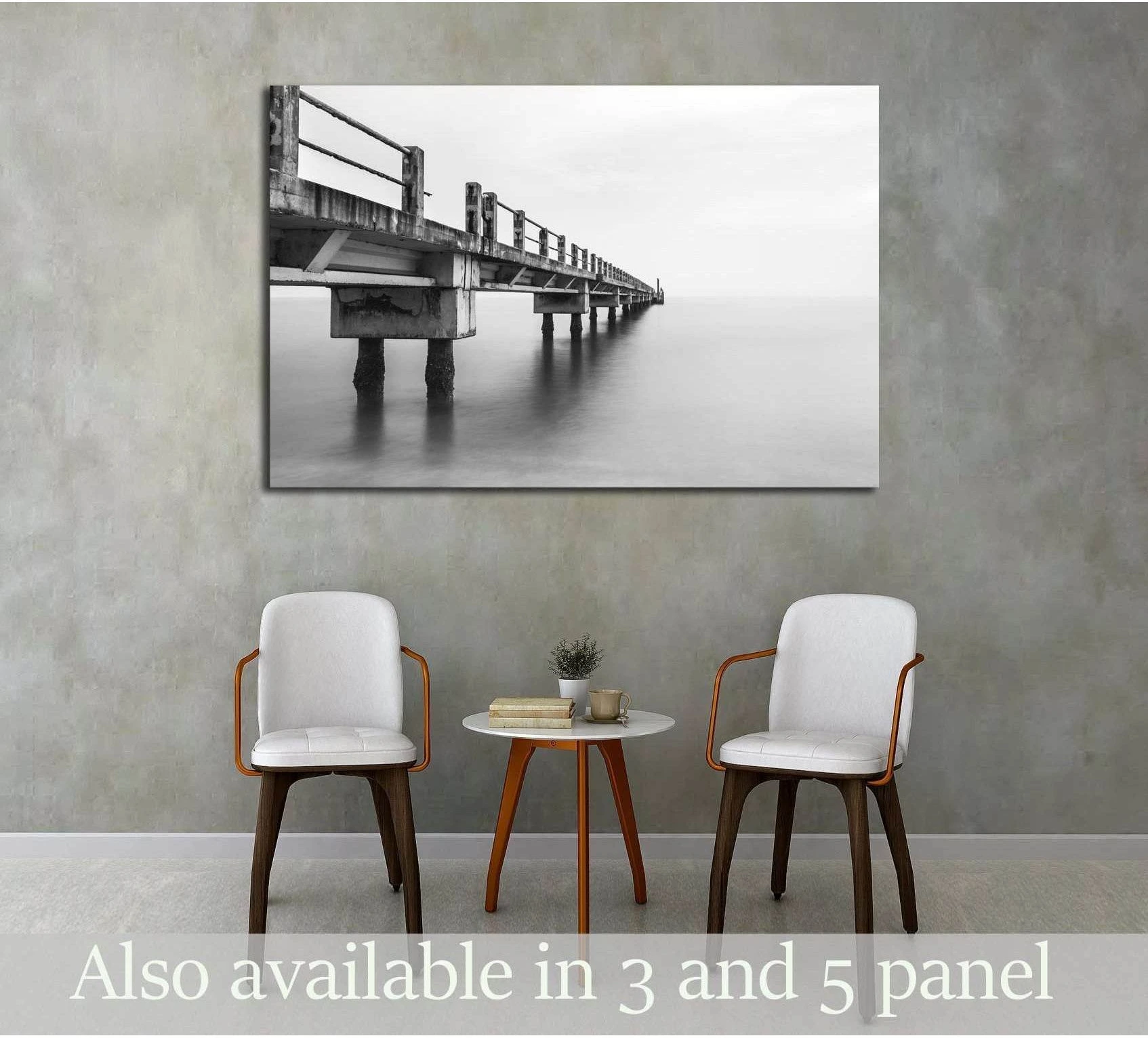 Black and white abandoned jetty canvas print hung above chairs in a minimalist waiting room