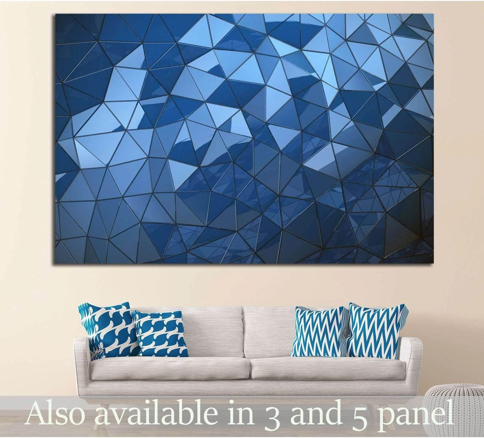Blue polygon abstract canvas print with faceted geometric shapes above a sofa in a modern living room