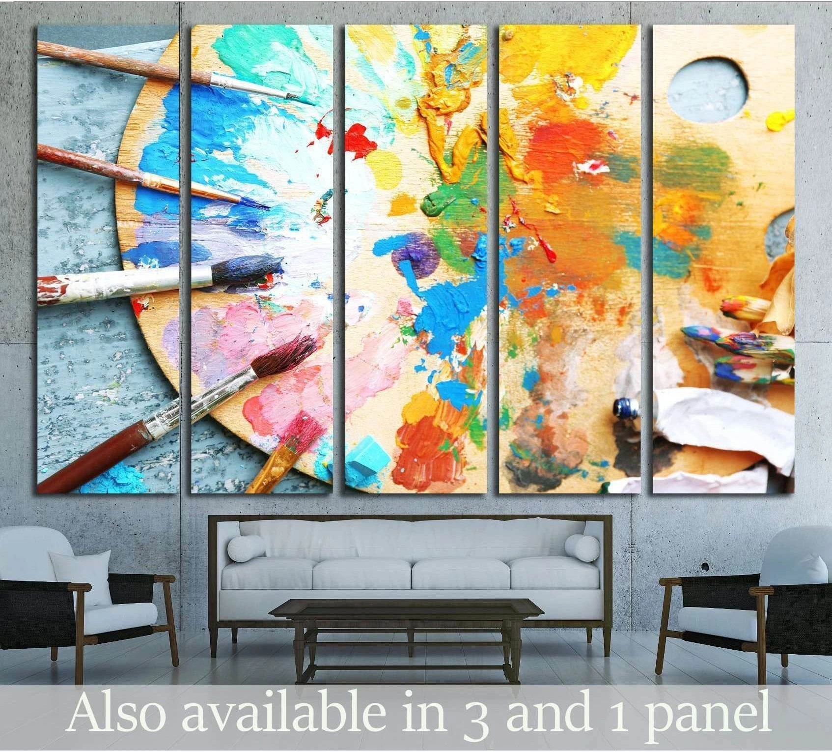 Painter palette canvas print with colorful paint smears and brushes above a sofa in a modern living room