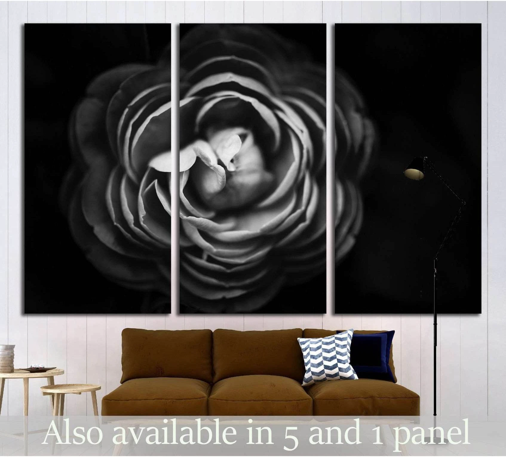 Black and white floral triptych canvas print above a sofa in a modern living room