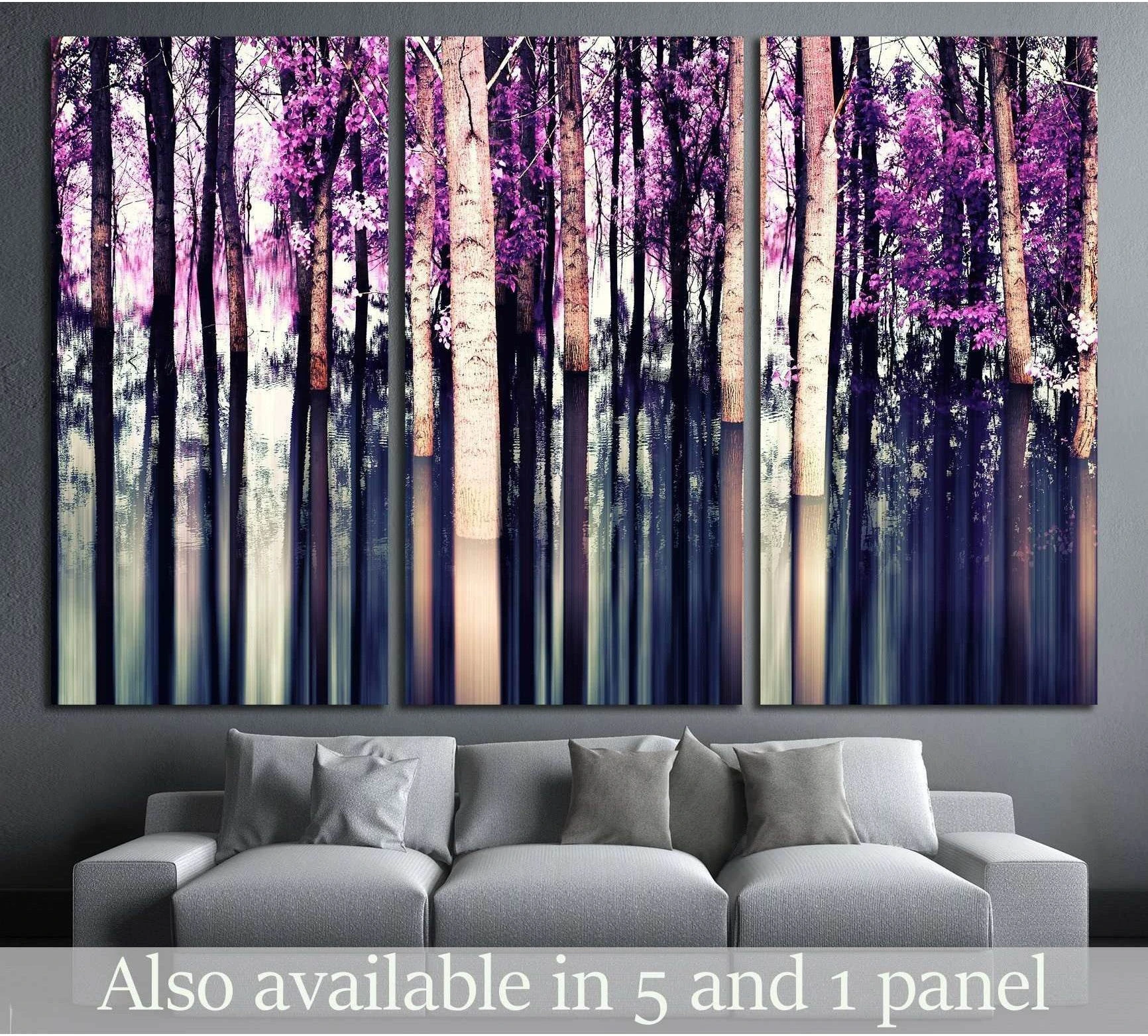 Purple forest canvas print with birch trunks and motion blur, displayed above a gray sofa