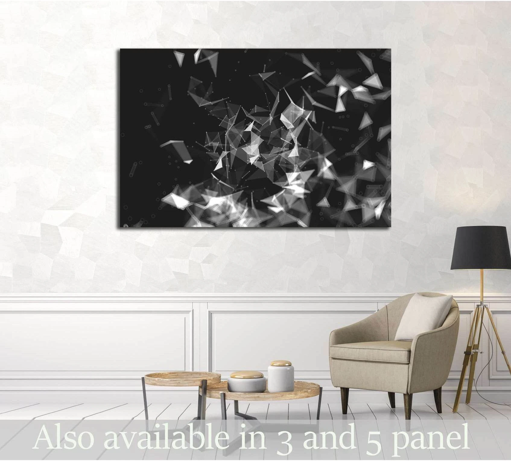 Black and white low-poly triangle canvas print hung above a sofa in a modern neutral living room