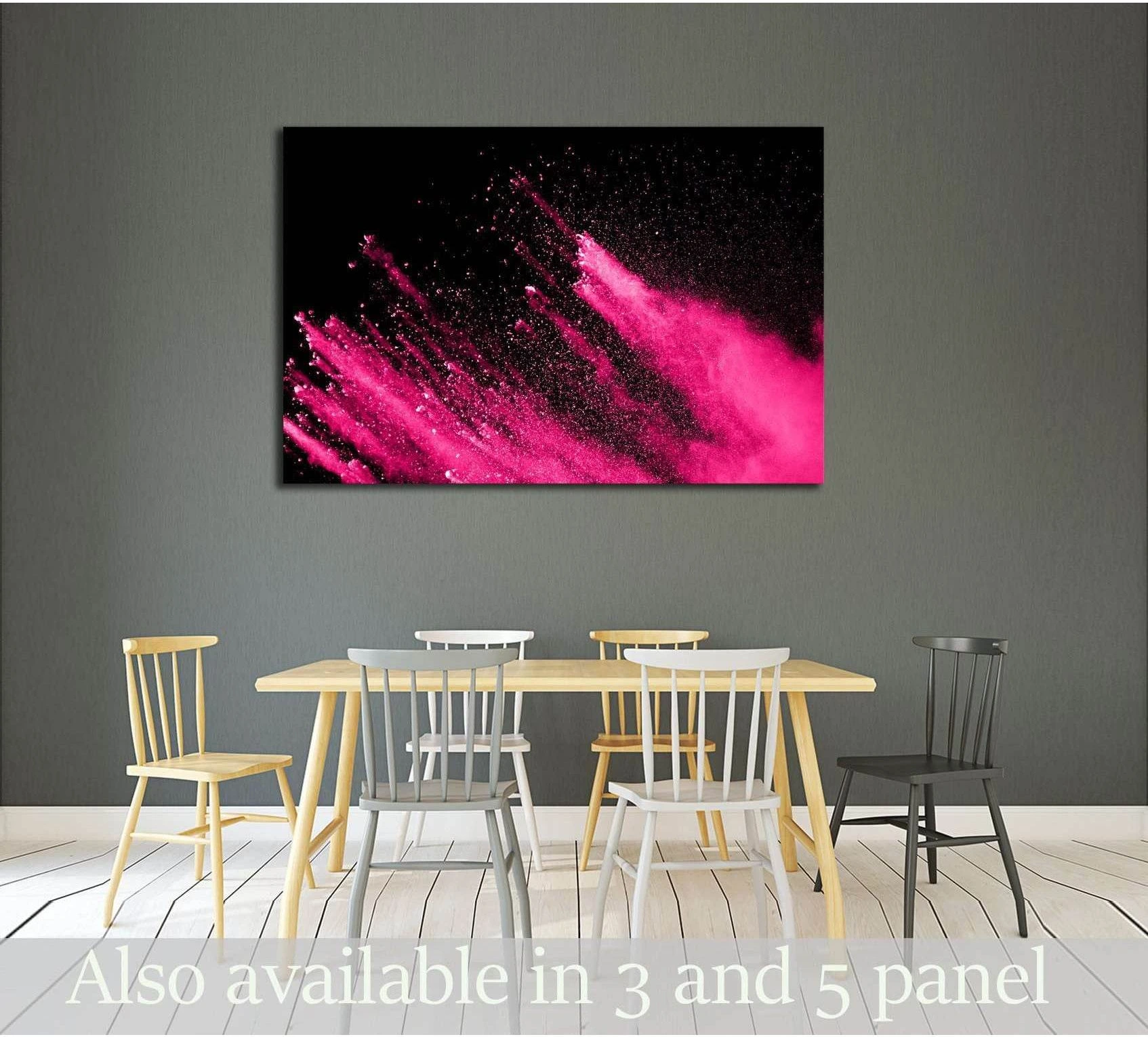 Abstract pink powder explosion canvas print on black background hung above dining table in a modern room