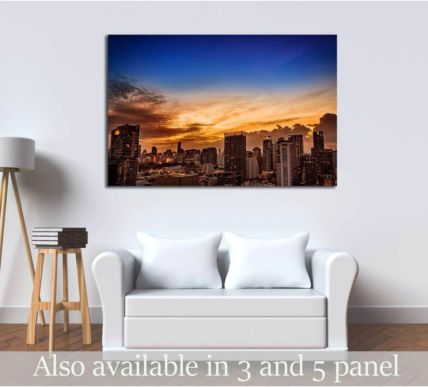 Sunset city skyline canvas print hung above a white sofa in a modern living room