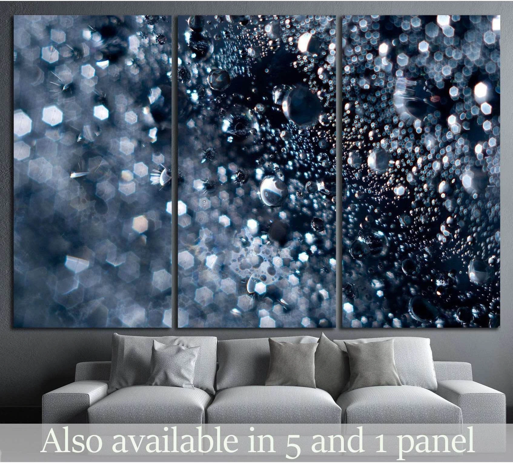 Abstract water bubbles canvas print with blue silver droplets and bokeh light above a sofa in a modern living room