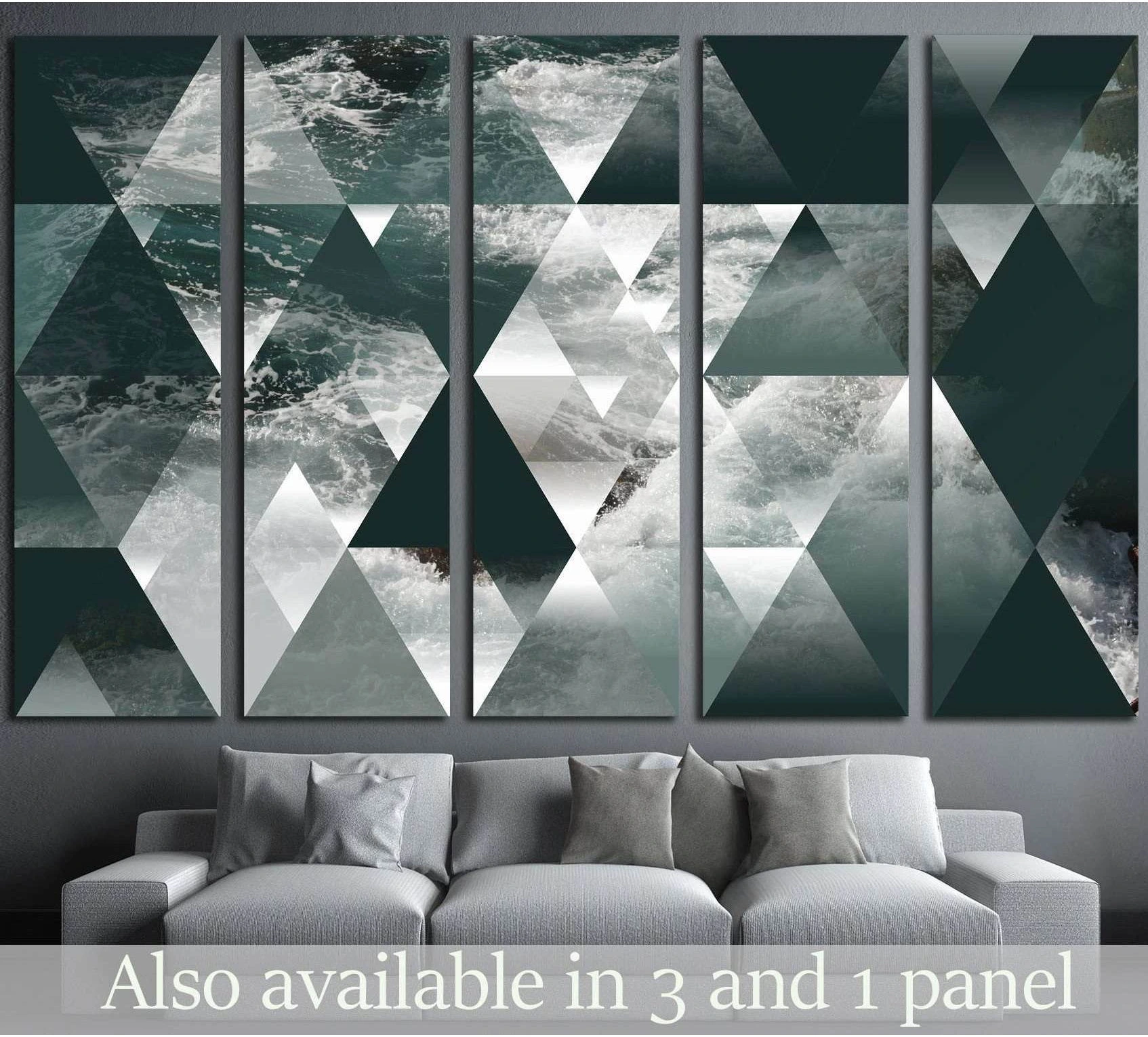 Geometric ocean canvas print in teal and gray triangles above a sofa in a modern living room