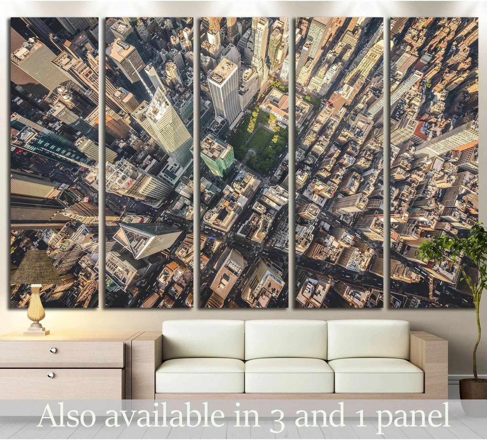 NYC aerial canvas print of Manhattan streets and skyscrapers above a sofa in a modern living room