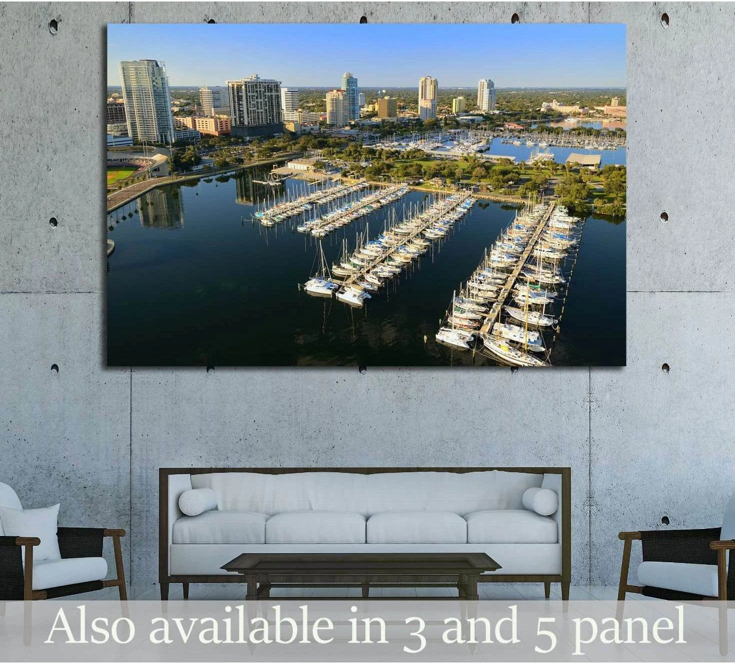 Aerial St. Petersburg marina canvas print showing sailboats, downtown skyline, and blue waterfront above a sofa in a modern living room
