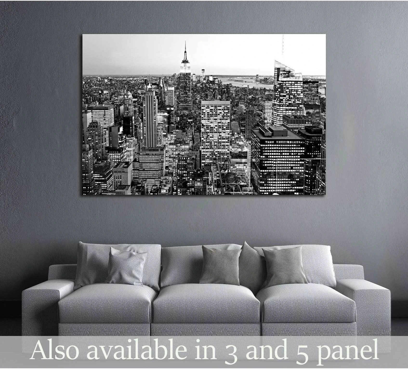 Black and white aerial Manhattan skyline canvas print above a sofa in a modern living room