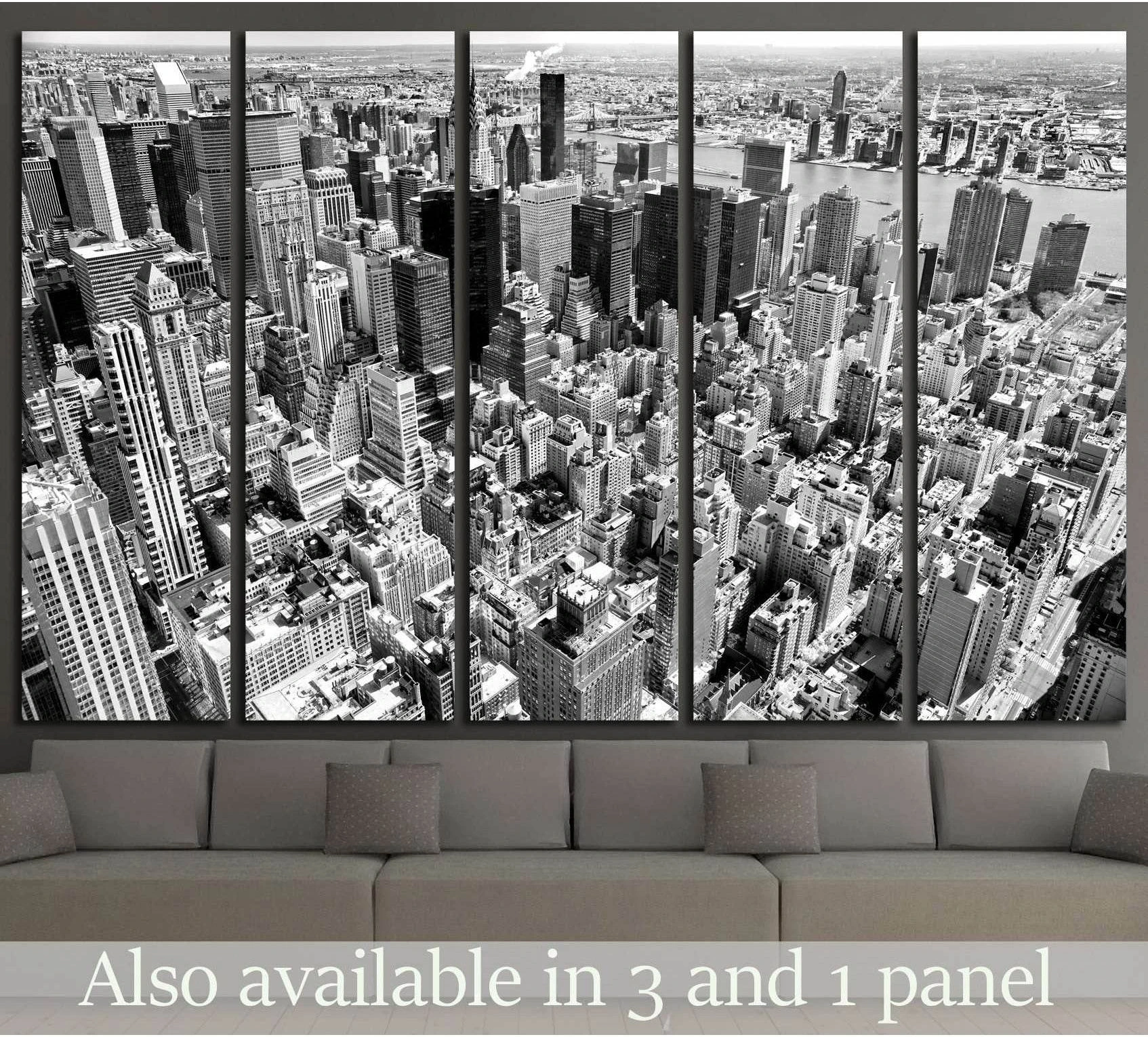 Black and white Manhattan aerial multi-panel canvas print above sofa in modern living room