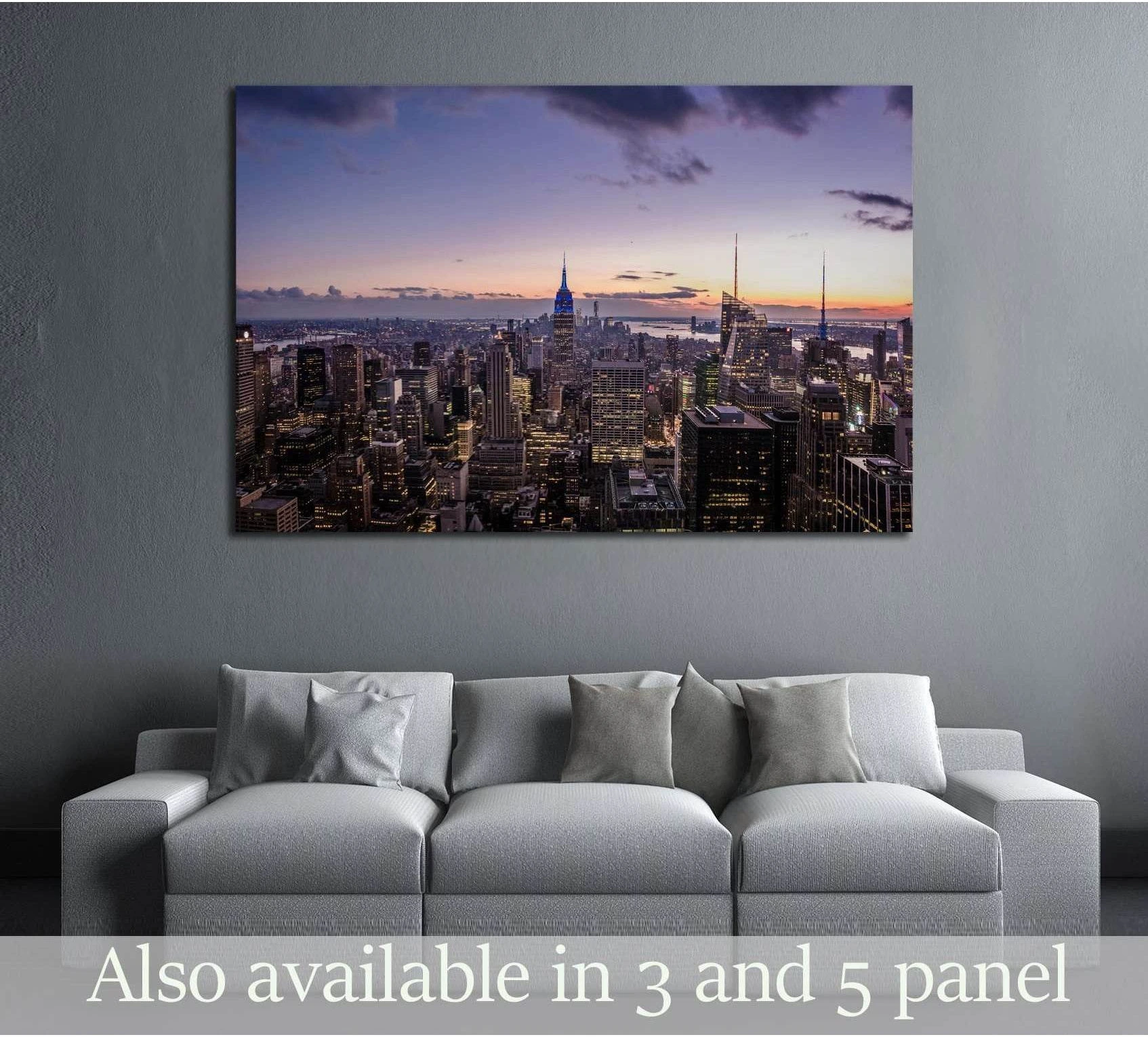Aerial Manhattan skyline canvas print at sunset above sofa in a modern living room
