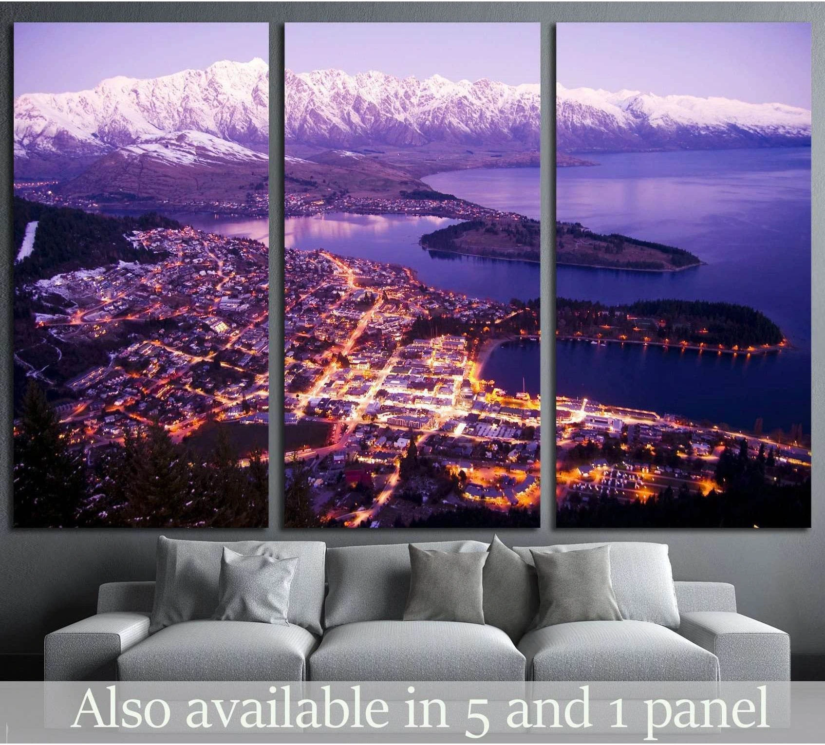 Queenstown night canvas print with city lights, Lake Wakatipu, and snowy mountains above a sofa