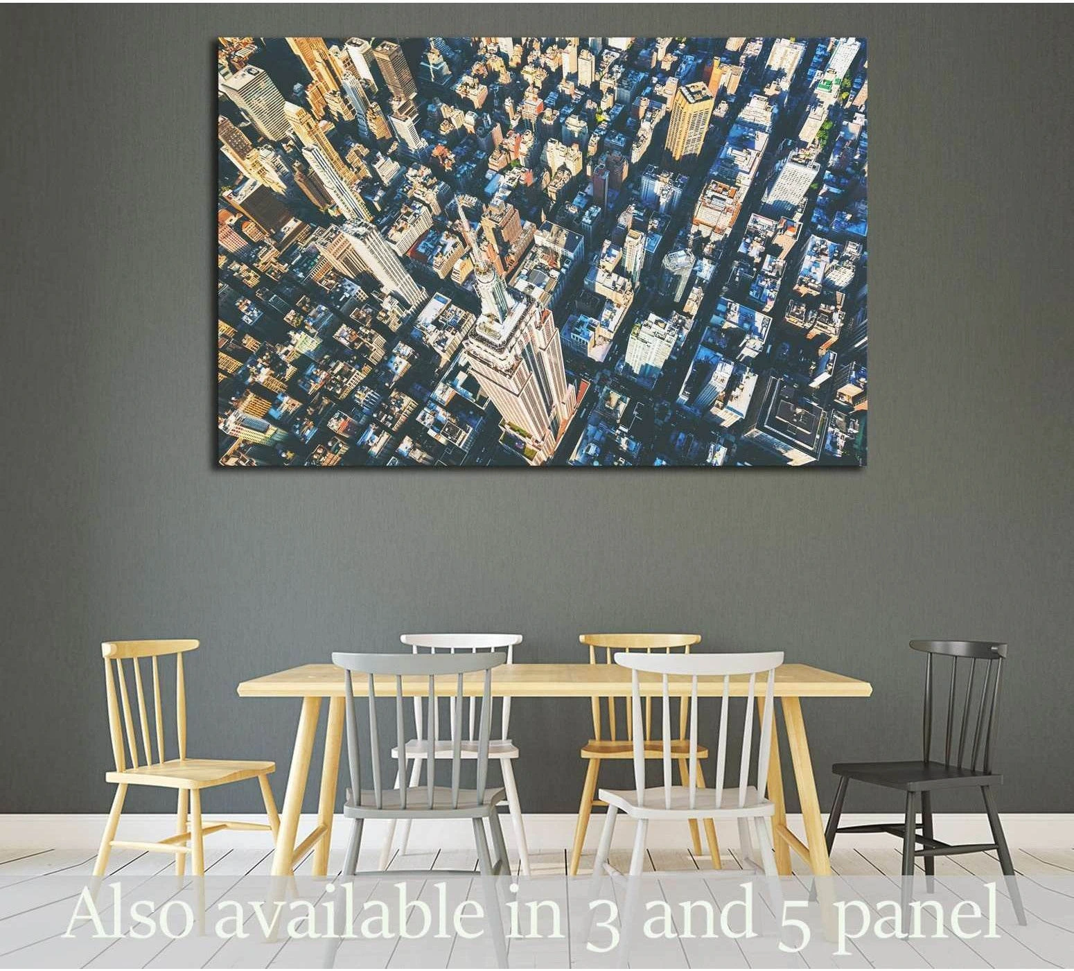 Aerial Midtown Manhattan canvas print with Empire State Building above a dining table on a dark gray wall