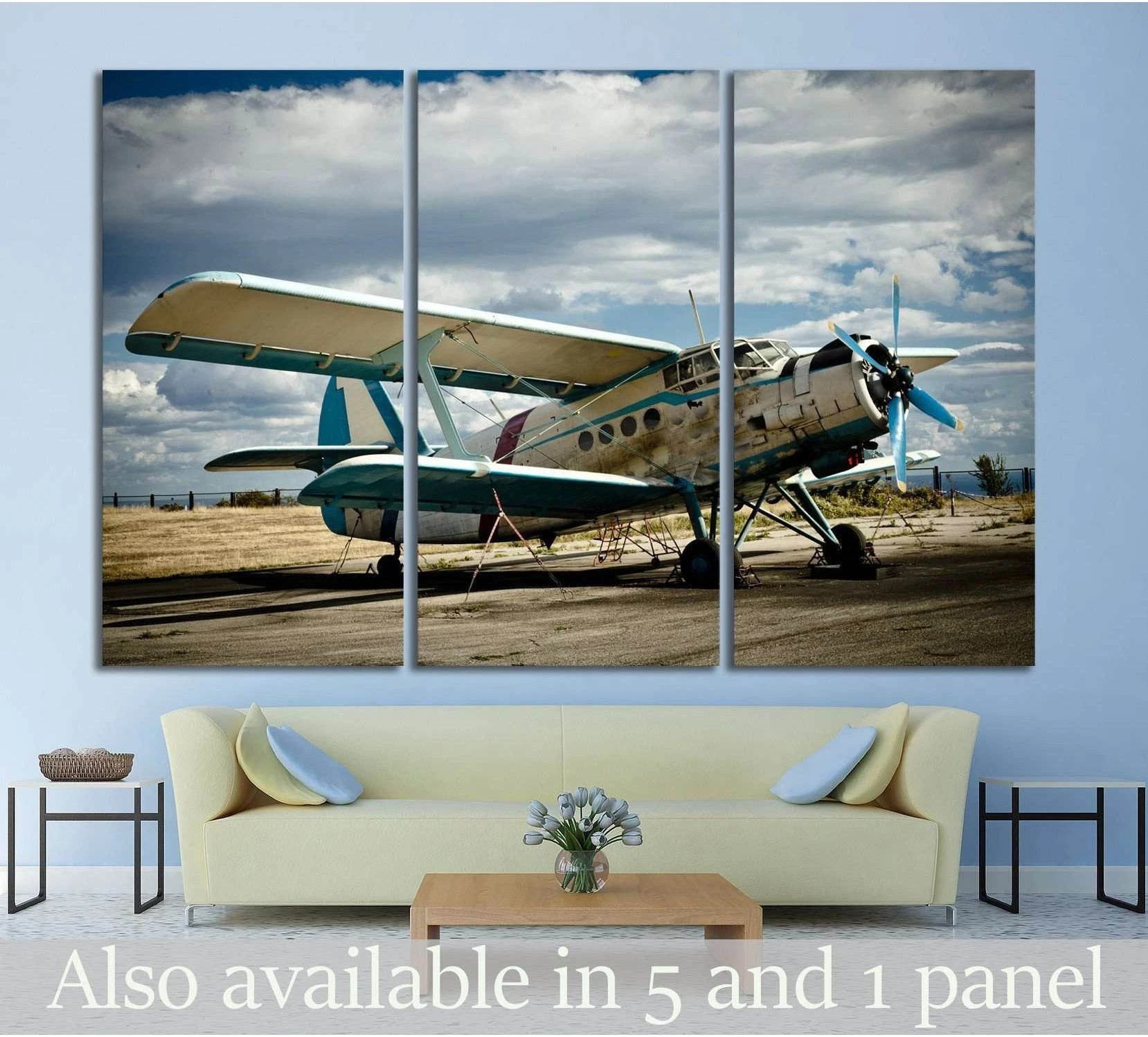 Vintage airplane triptych canvas print with weathered propeller aircraft above a sofa in a modern living room