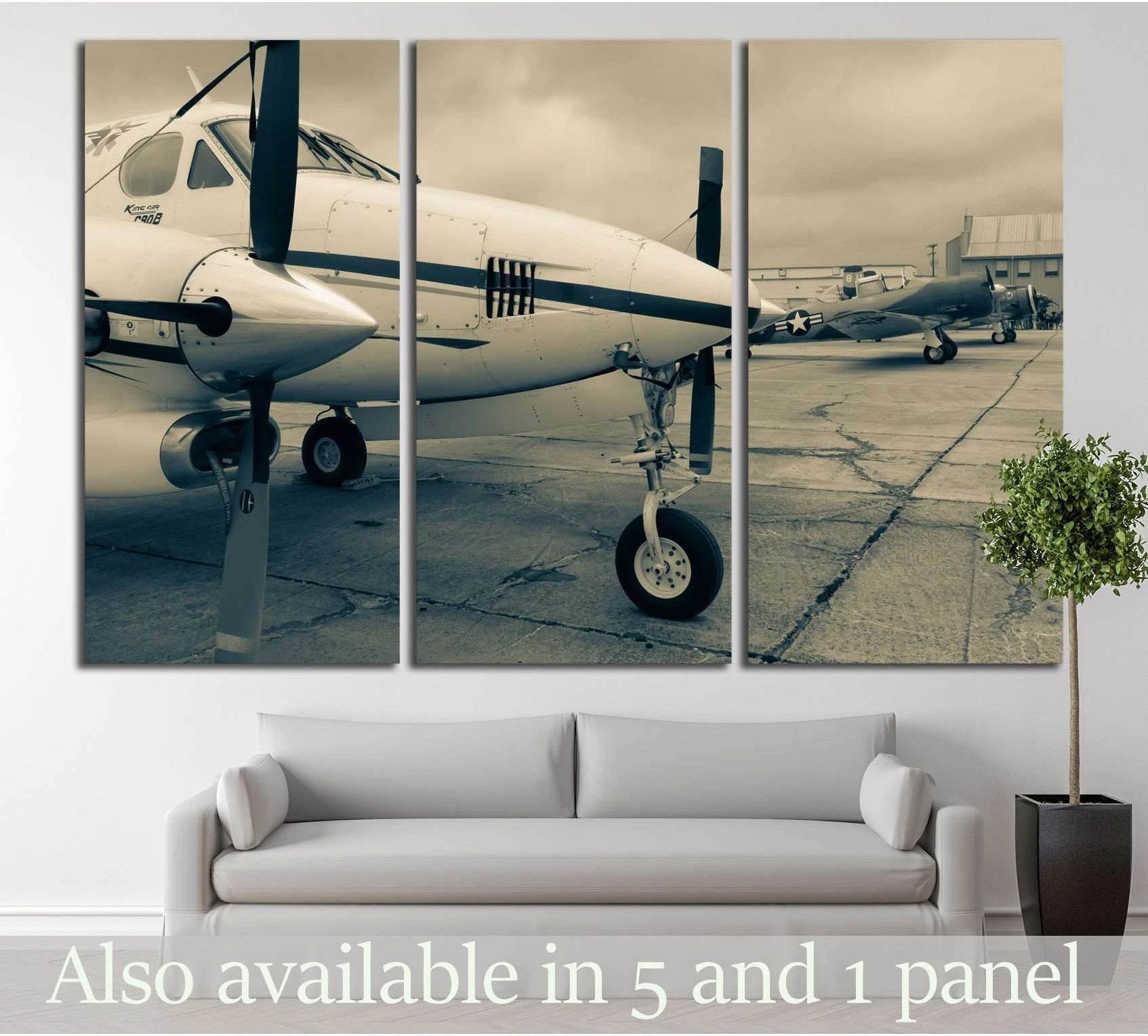 Sepia propeller airplane canvas print with two aircraft on a runway, displayed above a sofa