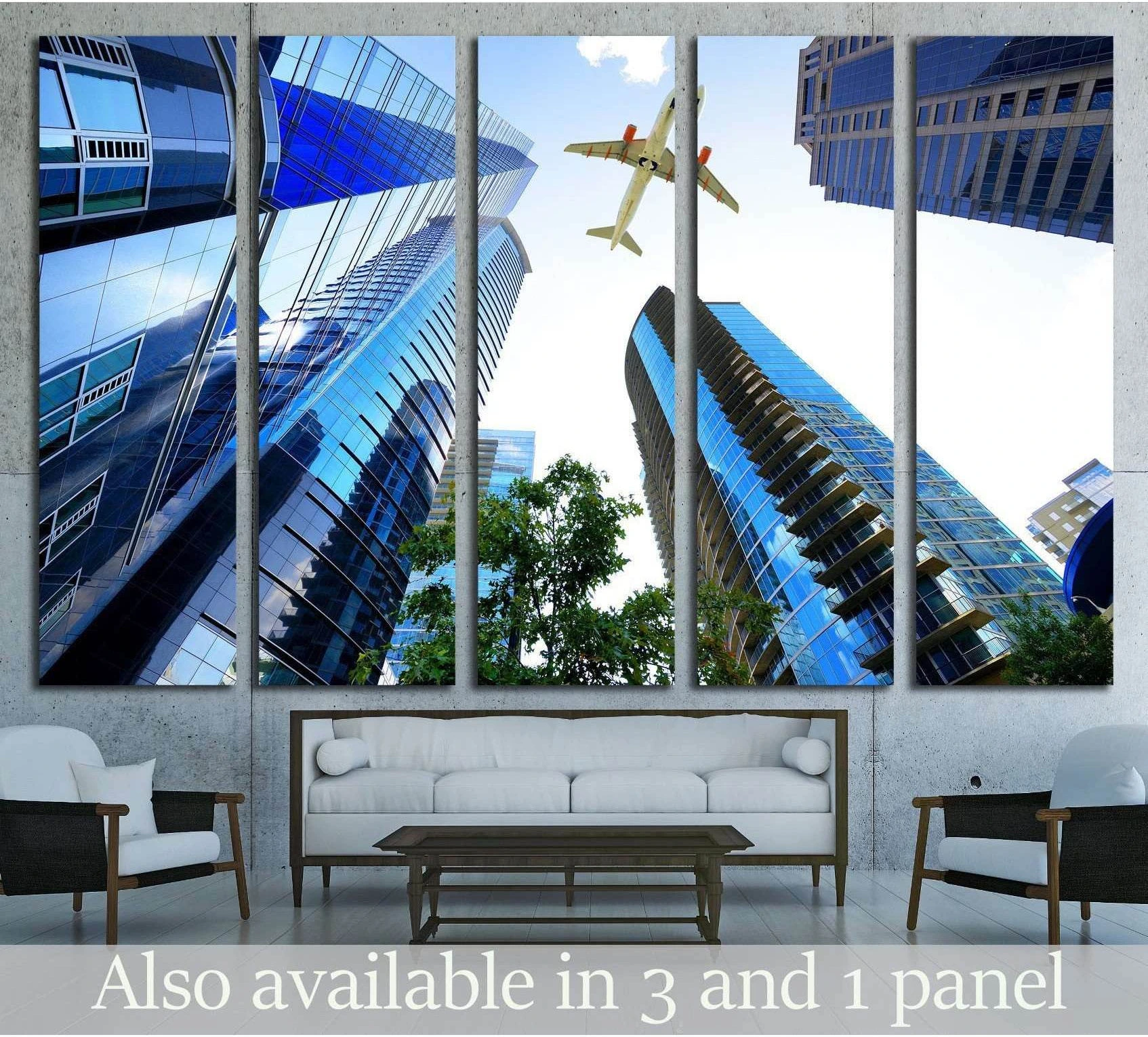 Airplane flying above blue Atlanta skyscrapers canvas print hung above a sofa in a modern living room