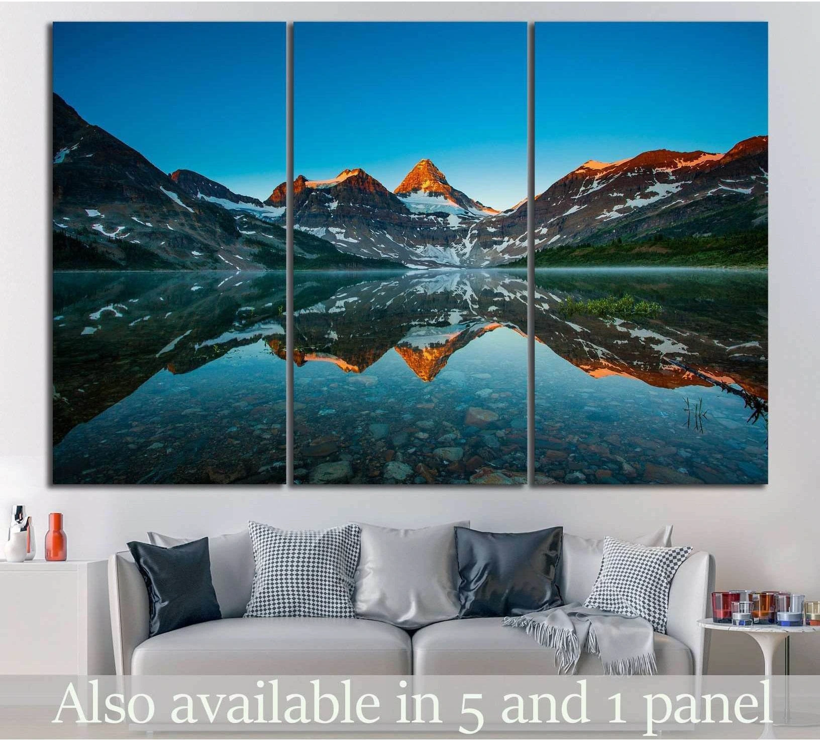 Alberta mountain lake canvas print with sunrise peaks and mirror reflection above a sofa