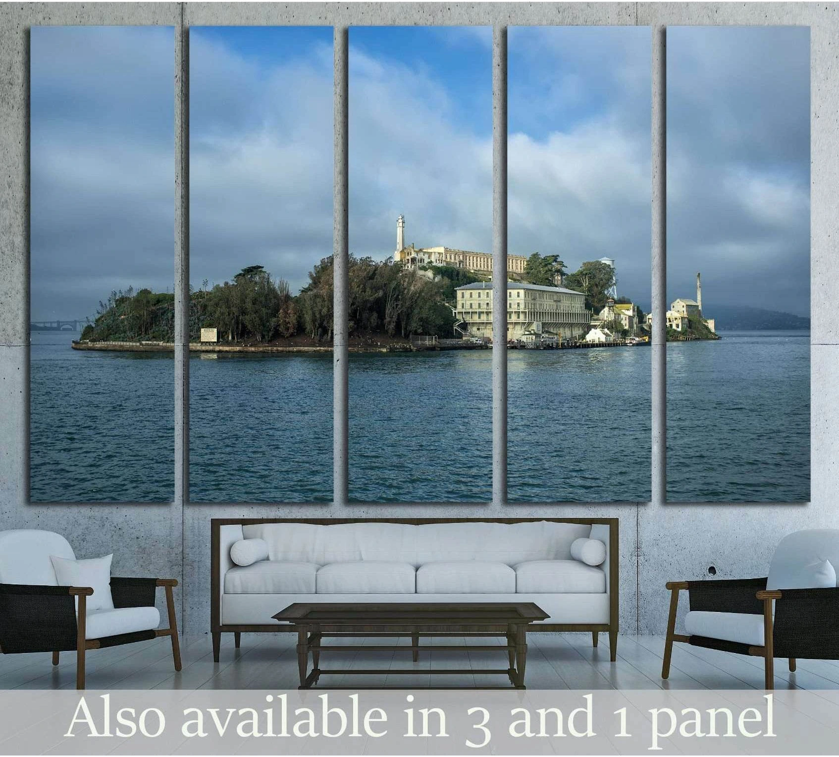 Alcatraz Island canvas print with prison buildings above blue bay water, hung above a sofa
