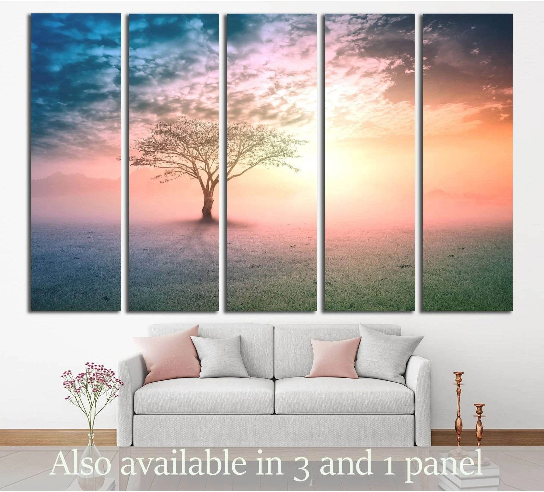 Lone tree canvas print in a misty sunrise meadow displayed above a sofa in a modern living room