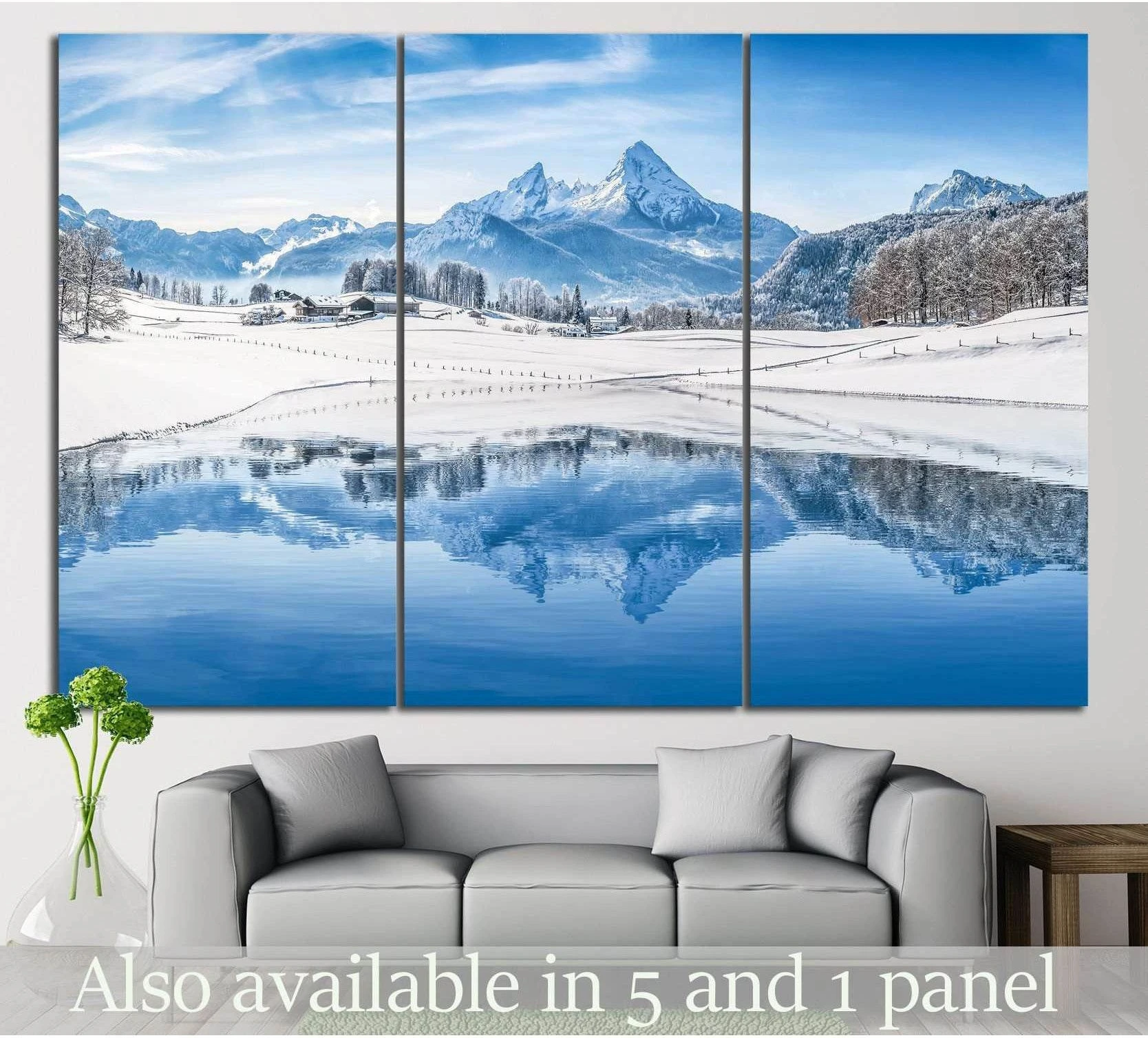 Snowy Alps mountain lake canvas print displayed as a triptych above a sofa in a modern living room
