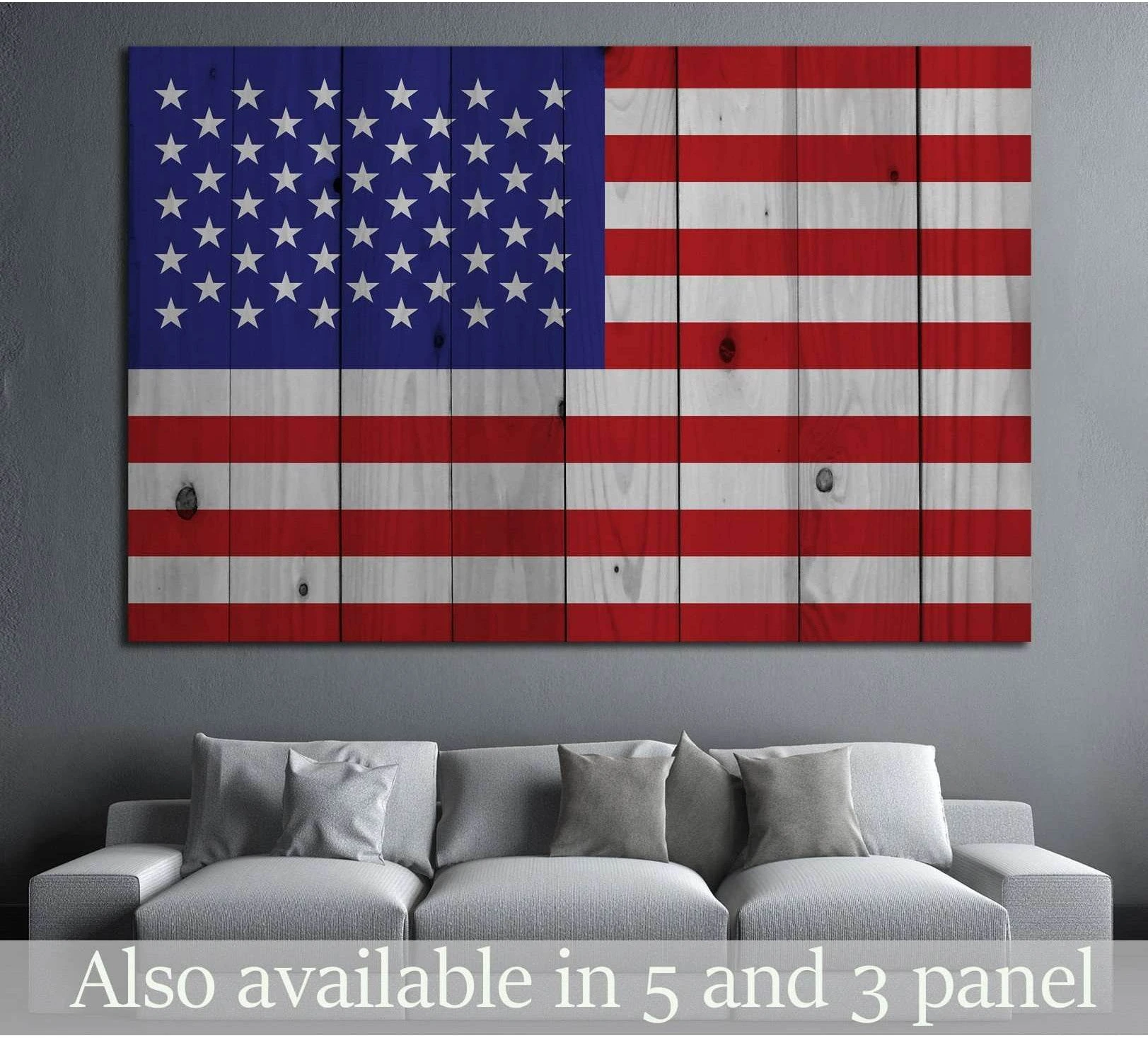 Rustic American flag canvas print on vertical wood planks displayed above a gray sofa in a modern living room