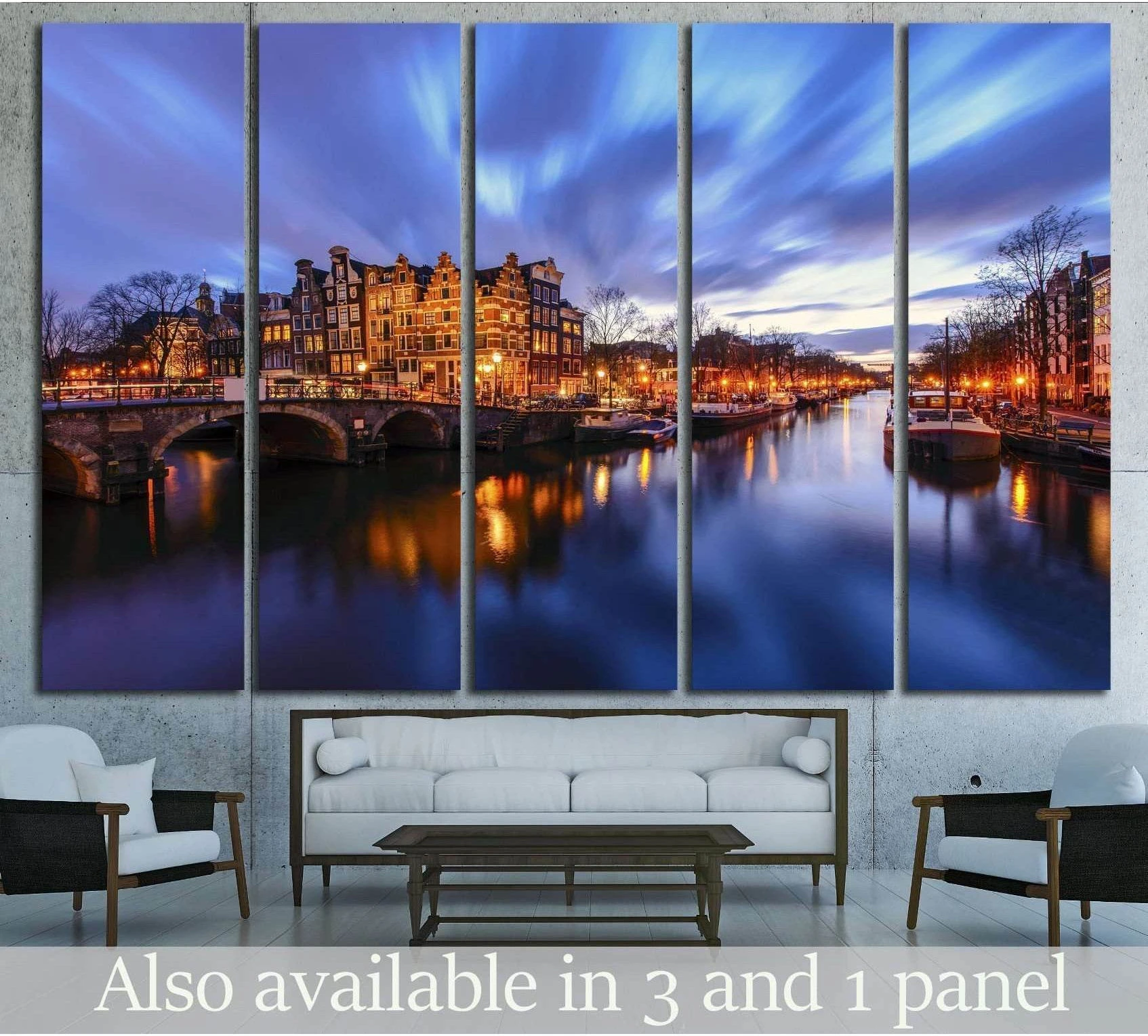 Amsterdam canal canvas print at twilight with glowing bridge lights above a sofa in a modern living room