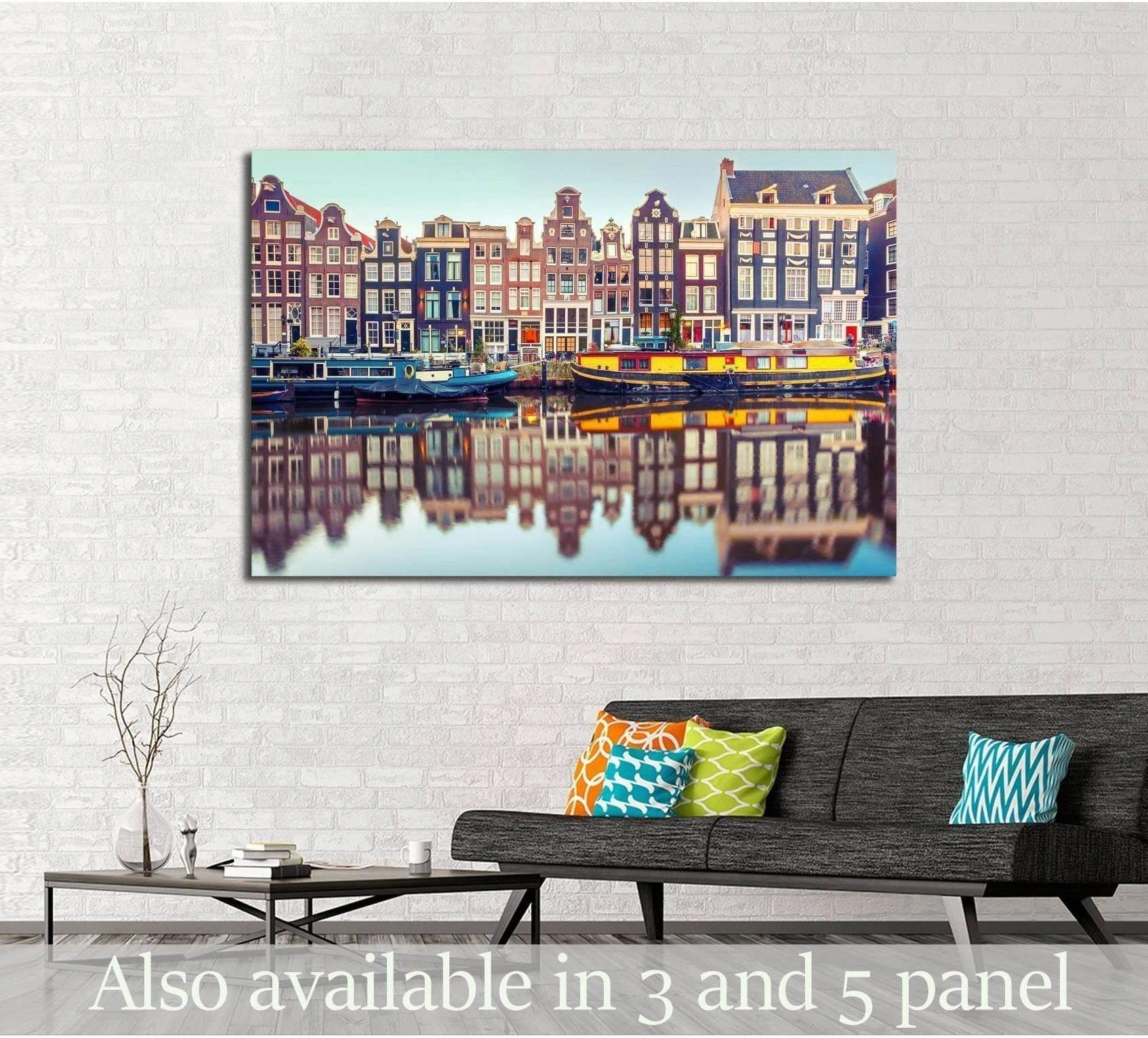 Amsterdam canal houses canvas print with Dutch gabled buildings and water reflections above a sofa