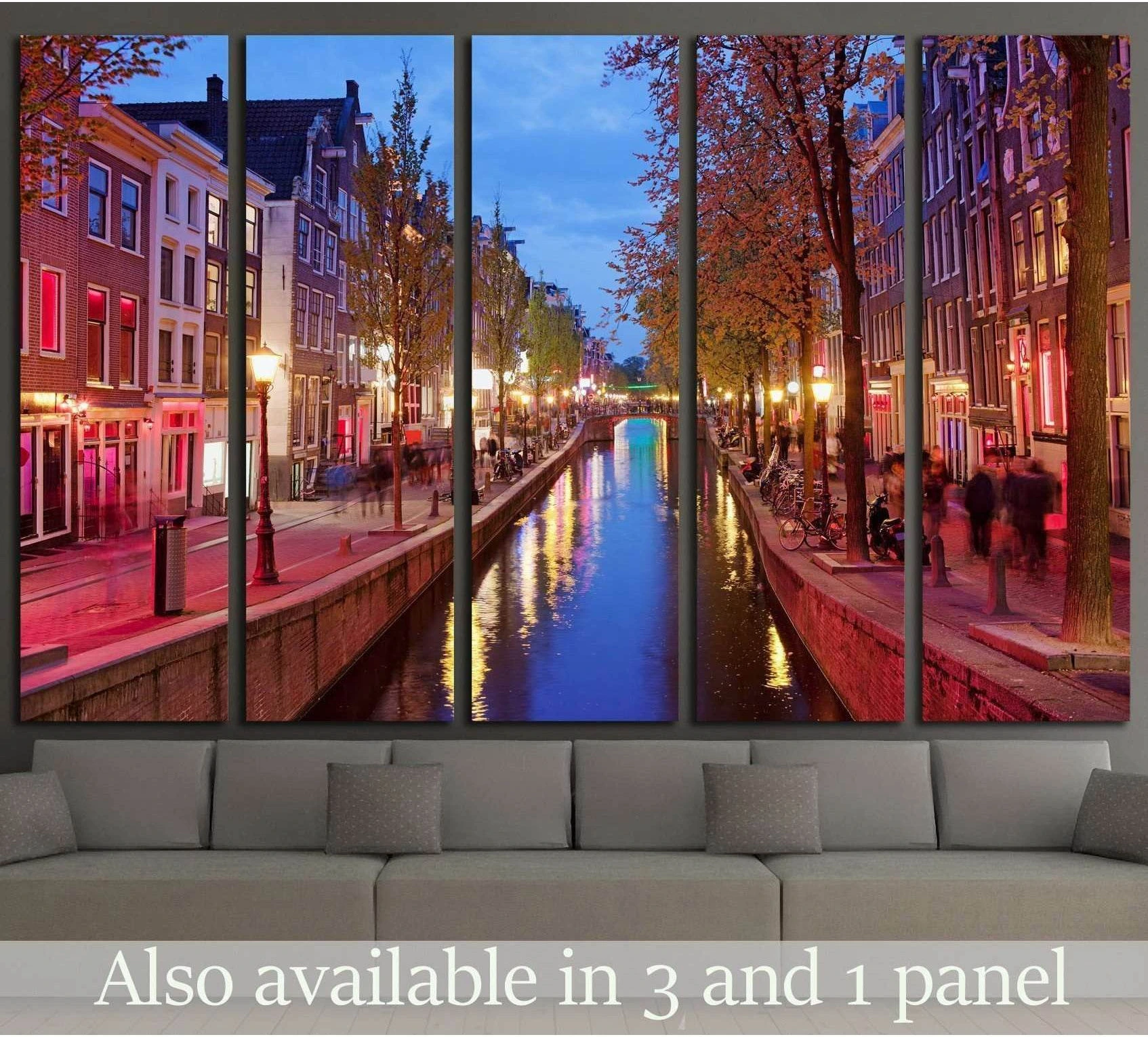 Amsterdam canal canvas print of the Red Light District at dusk above a sofa in a modern living room
