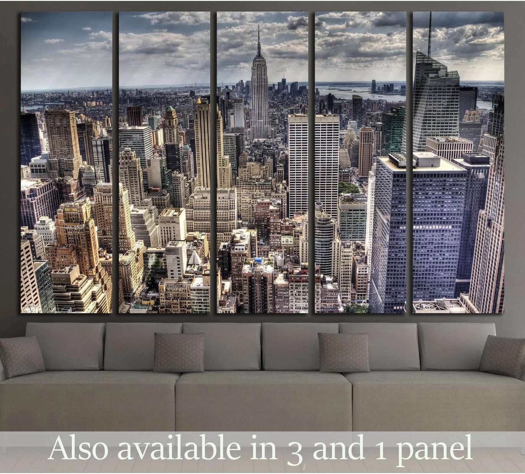Aerial NYC skyline canvas print with the Empire State Building above a sofa in a modern living room
