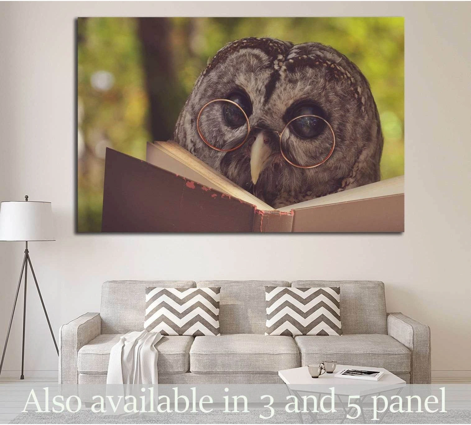 Owl reading canvas print with round glasses and open book above sofa in a neutral living room