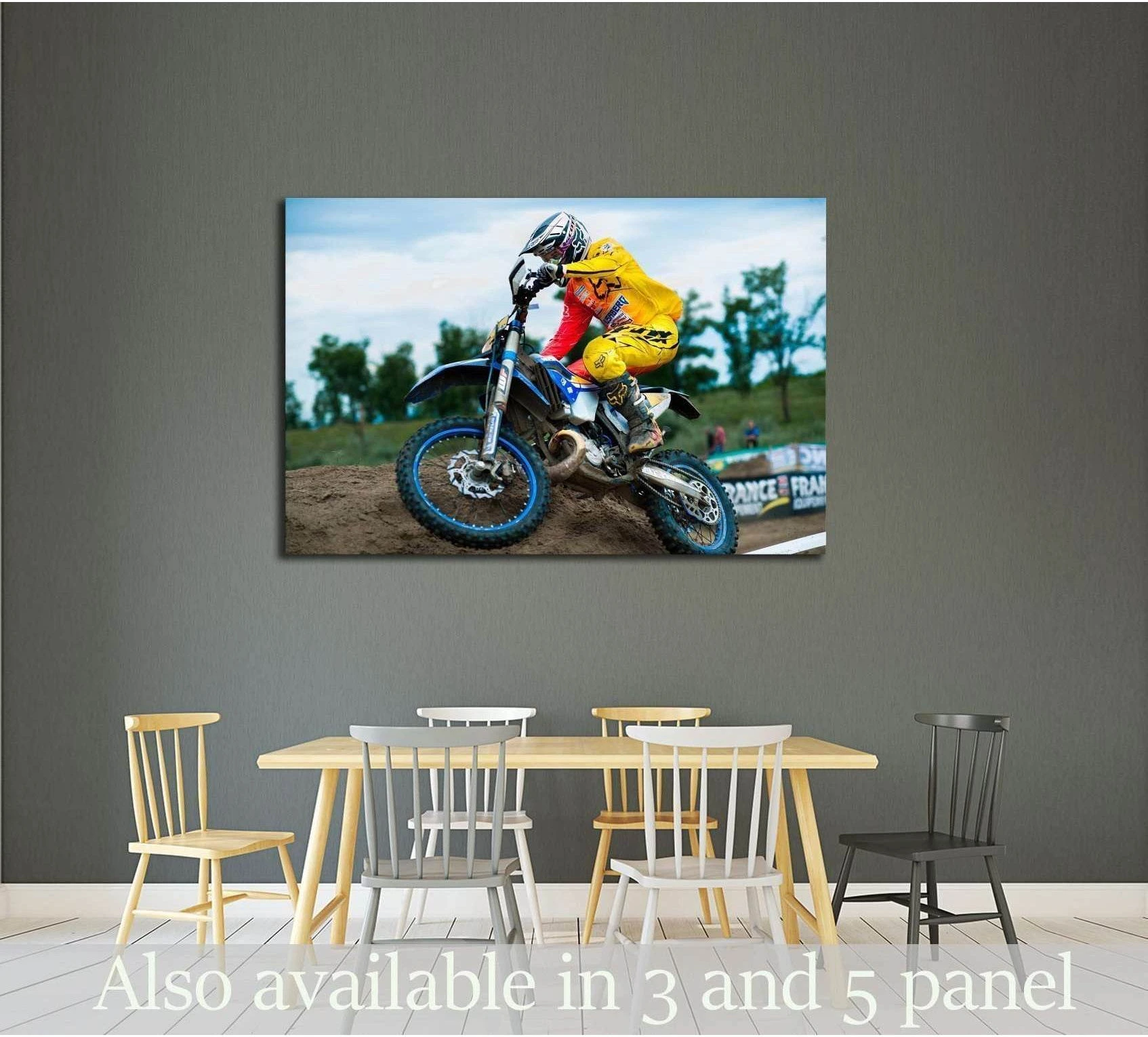 Motocross rider canvas print with yellow gear on a dirt track, displayed above a dining table