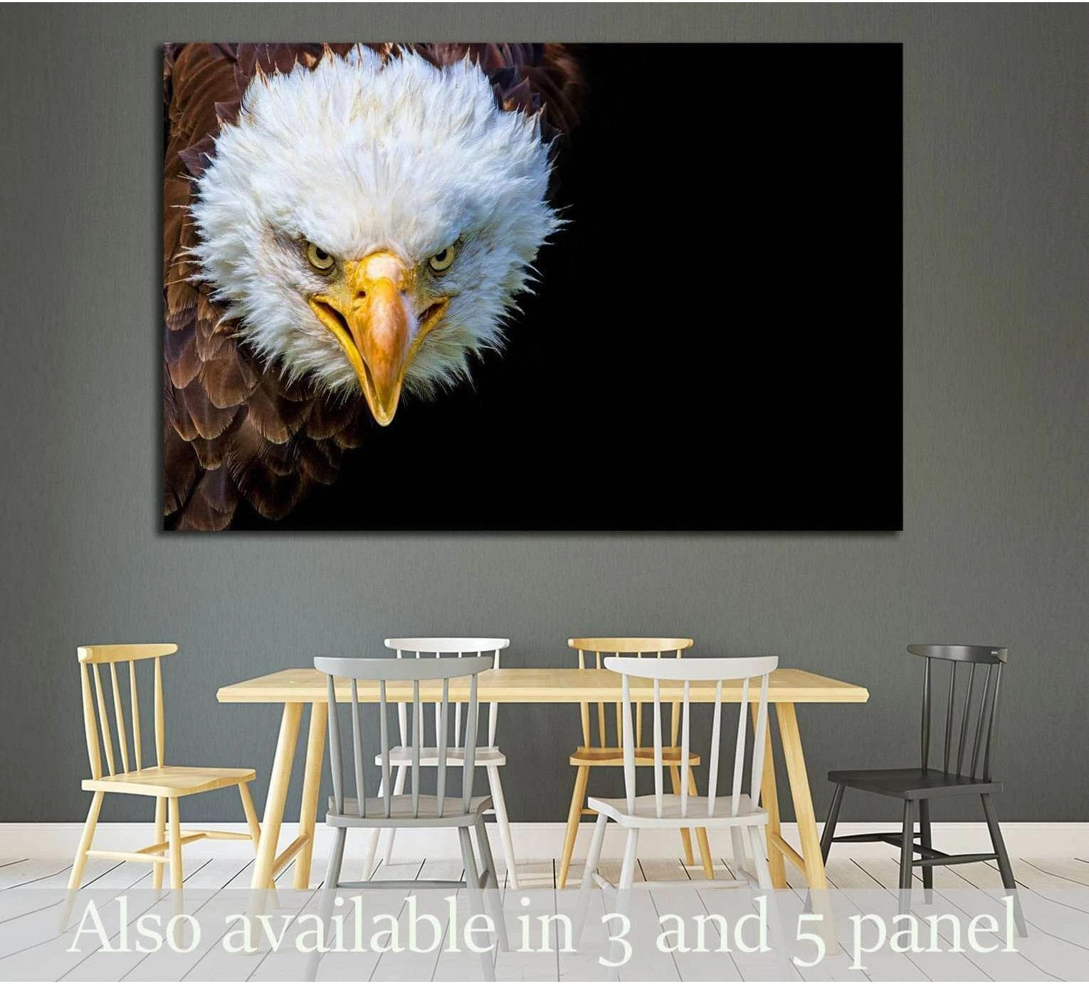 Bald eagle close-up canvas print on black background hung above a dining table in a modern room