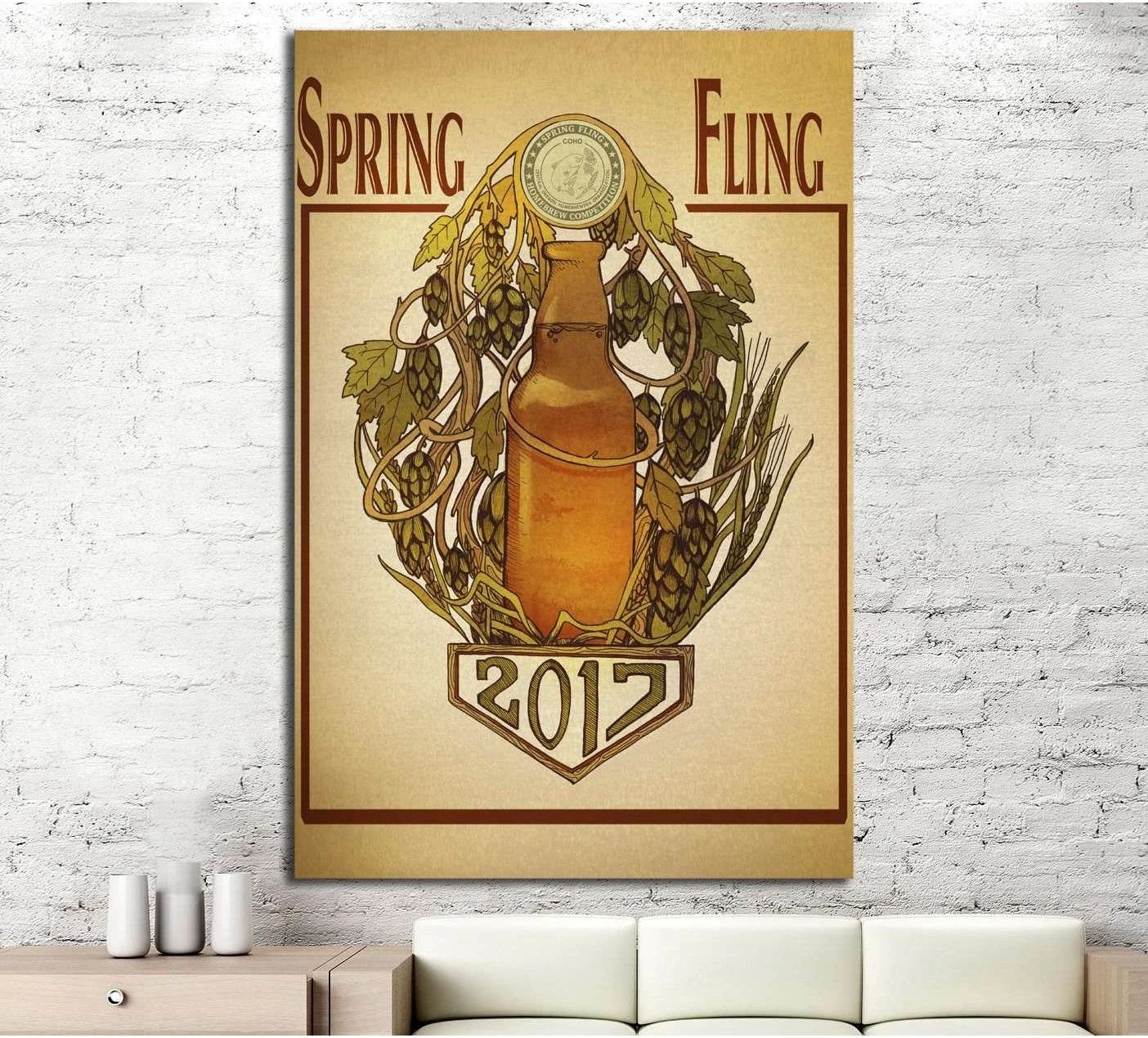 Vintage beer poster canvas print with amber bottle, hops, and wheat hung above a sofa