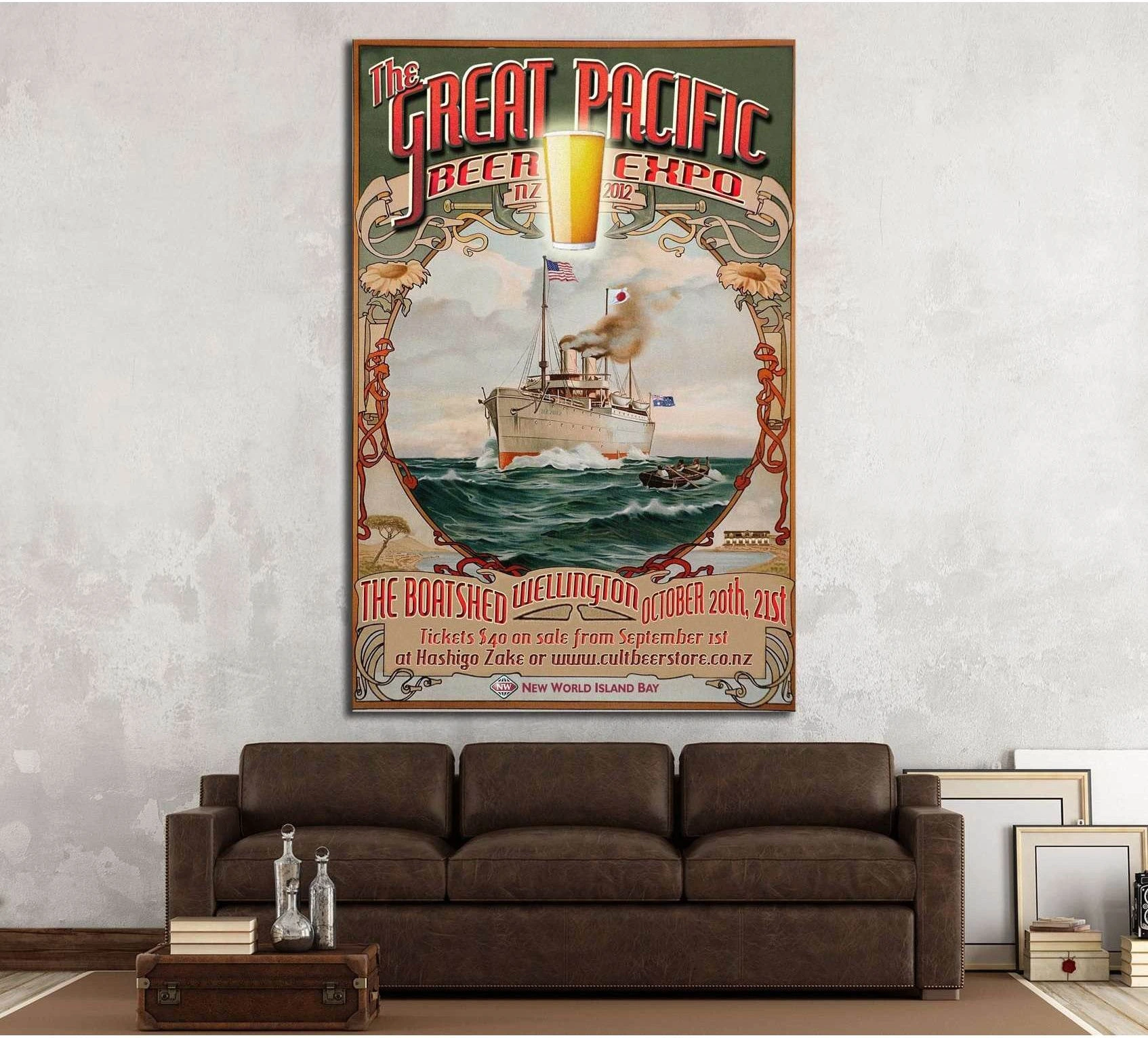 Vintage nautical beer poster canvas print with steamship and retro typography hung above a brown sofa in a rustic living room