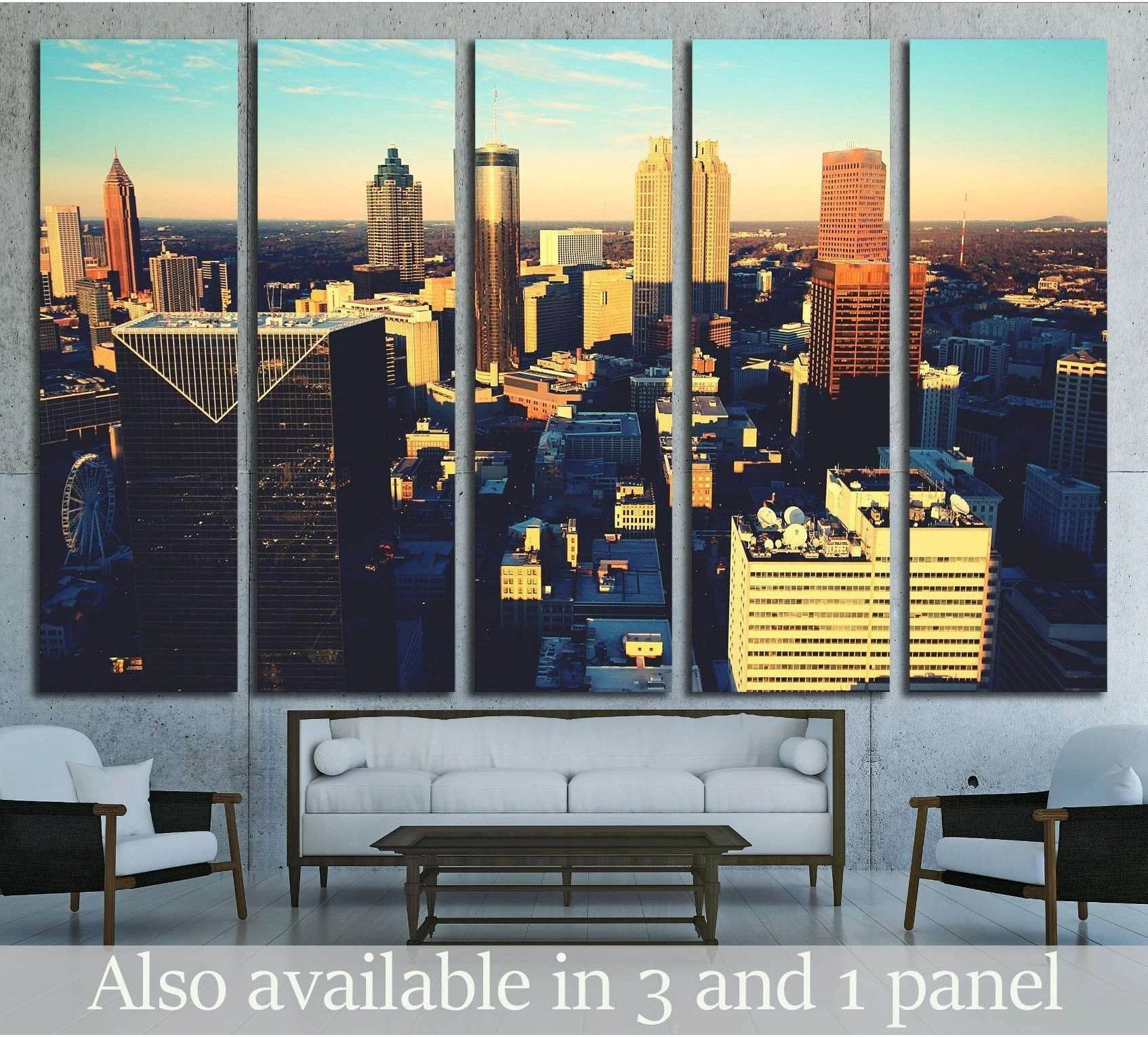 Atlanta skyline multi-panel canvas print in golden sunset tones above a sofa in a modern living room