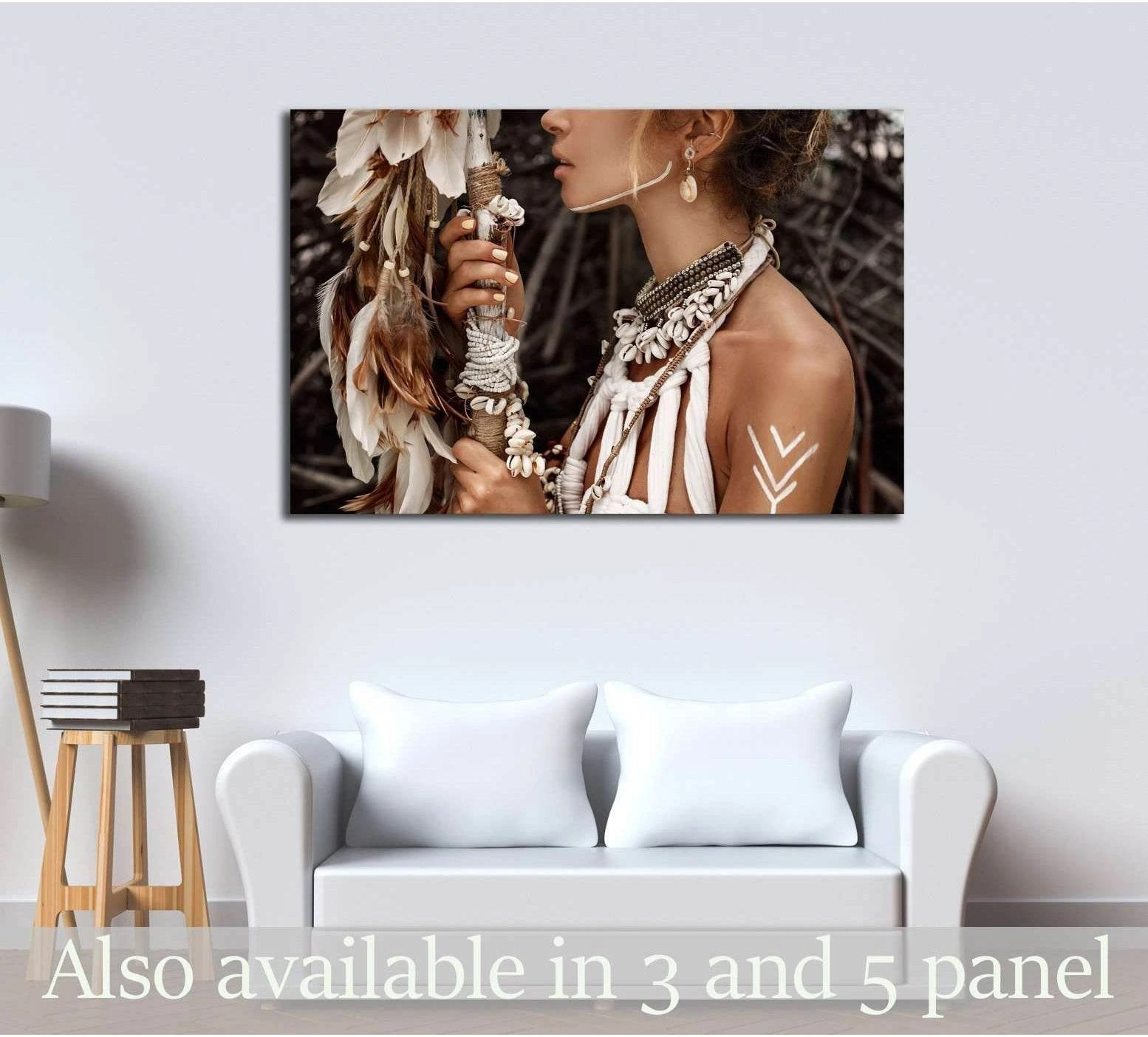 Boho woman canvas print with shell necklace, feathers, and white body paint above a sofa in a neutral living room
