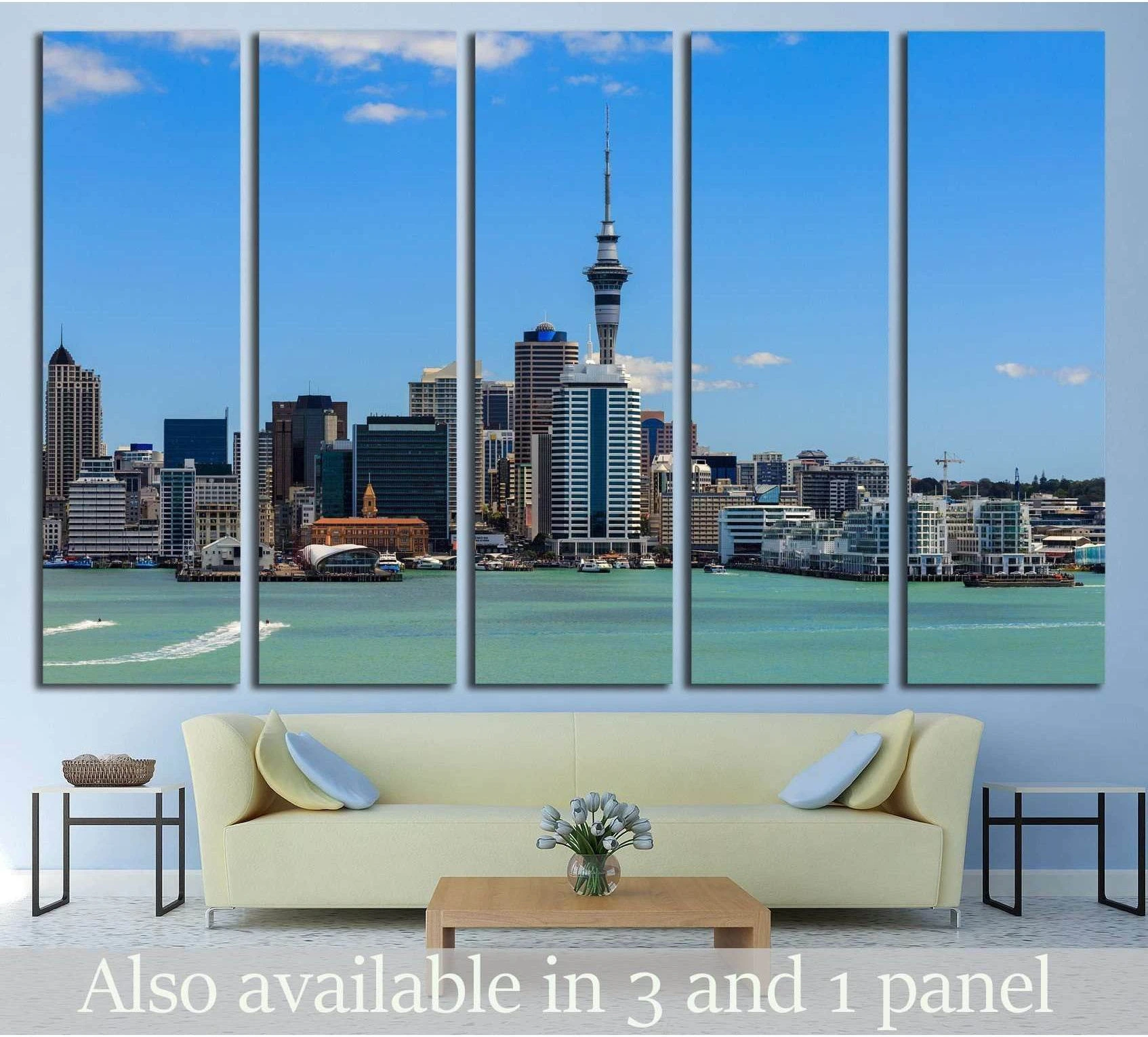 Auckland skyline canvas print with Sky Tower, turquoise harbor, and blue sky above a sofa