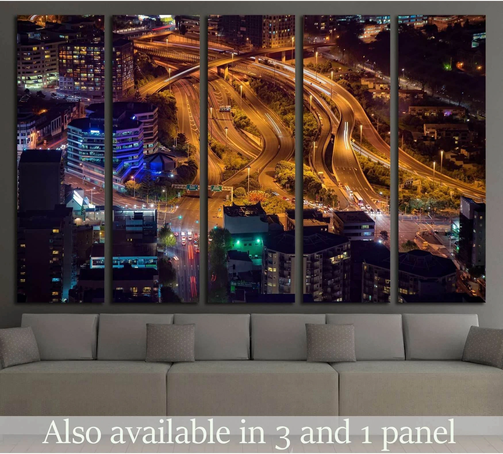 Auckland night cityscape canvas print with golden highway light trails, displayed above a sofa