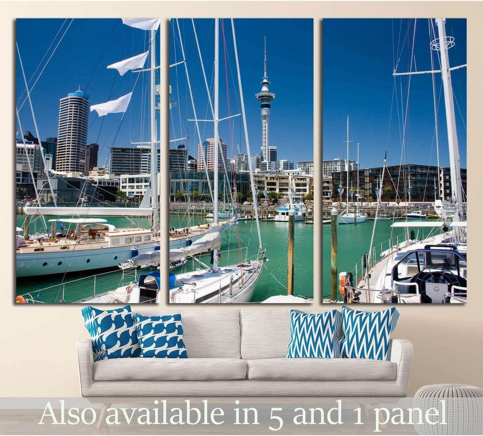 Auckland marina canvas print with sailboats, turquoise water, and Sky Tower above a sofa