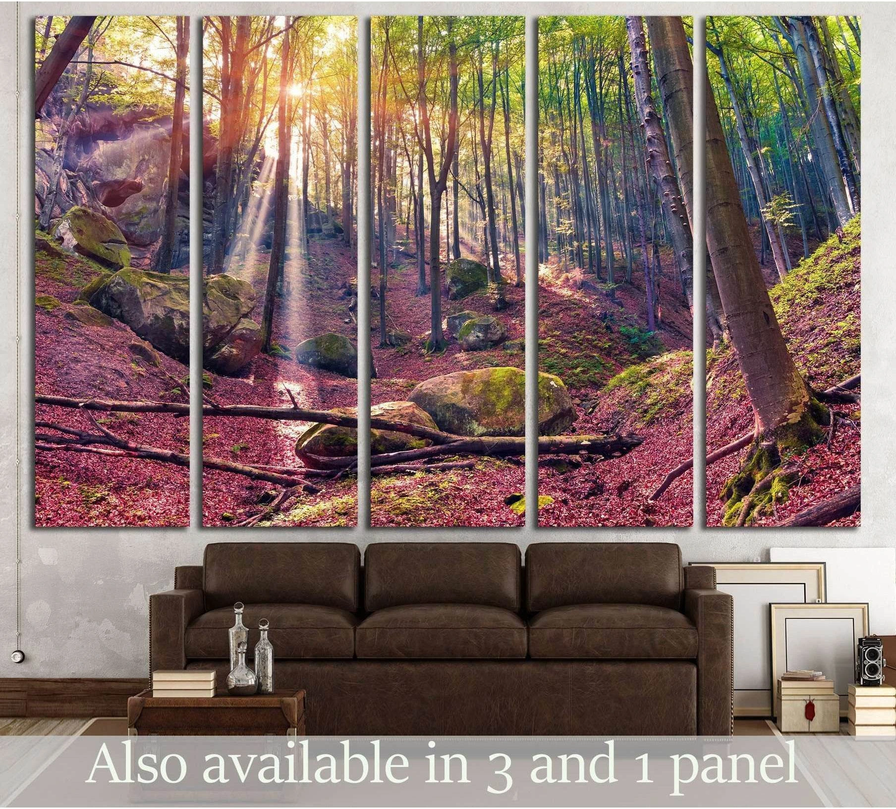 Autumn forest canvas print with sunrise rays through tall trees, displayed above a sofa in a modern living room