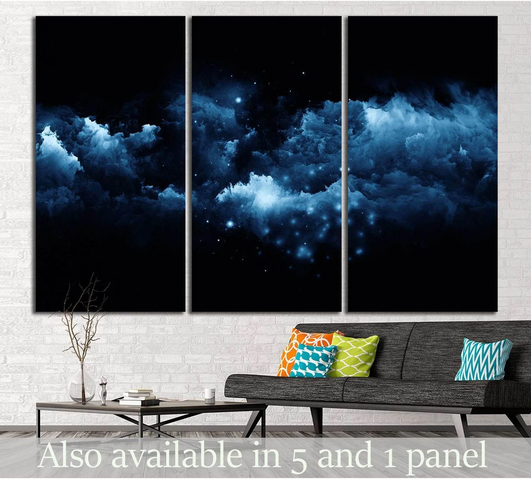 Blue nebula triptych canvas print with glowing cosmic clouds above a sofa in a modern living room