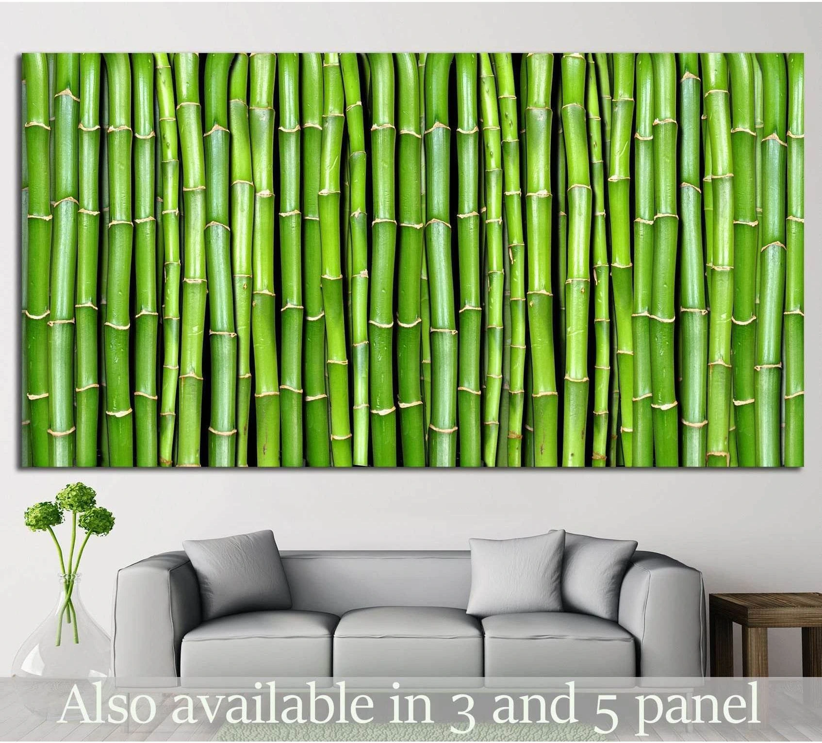 Green bamboo stalks canvas print hung above a sofa in a minimalist living room