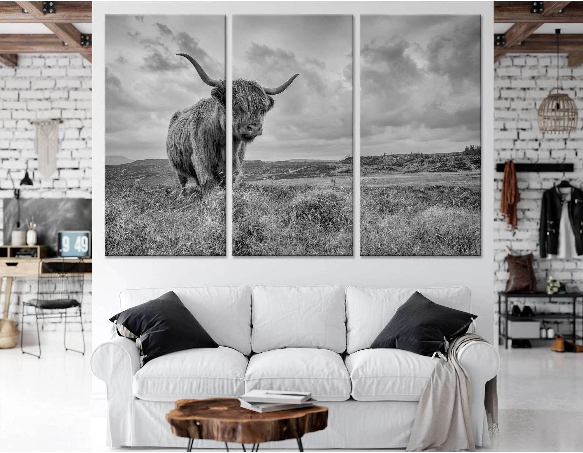 A black and white photograph of a Highland cow in a field of tall grass, with a dramatic sky and mountains in the background., product view 2