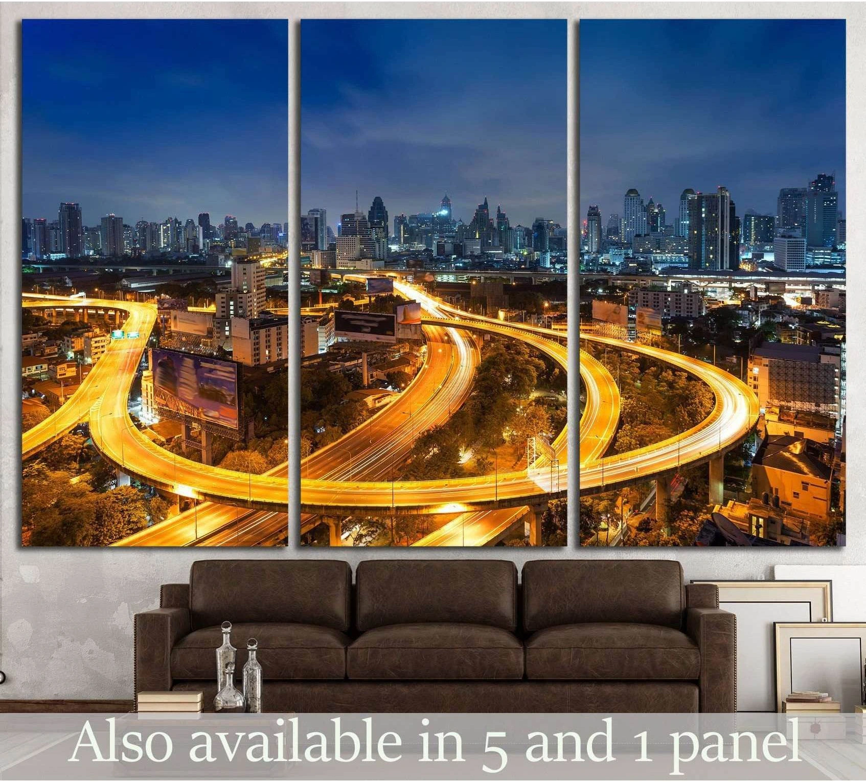 Bangkok skyline triptych canvas print with golden highway light trails above a brown sofa